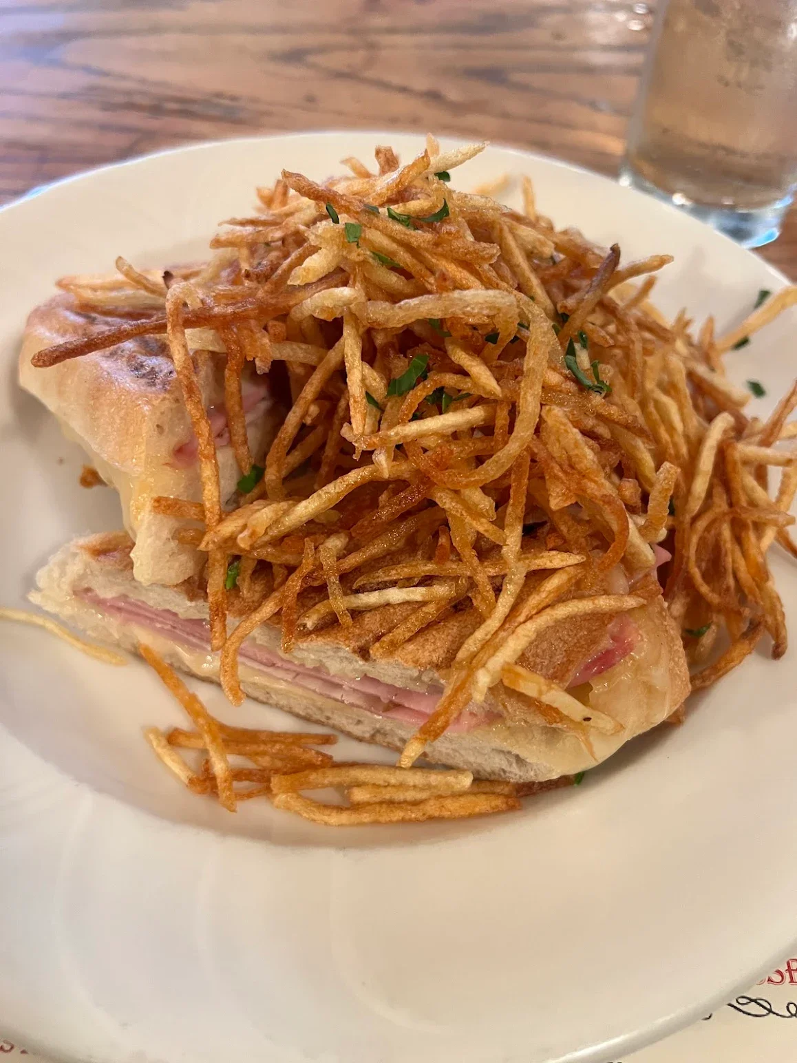 Cuban sandwich topped with crispy fried potatoes