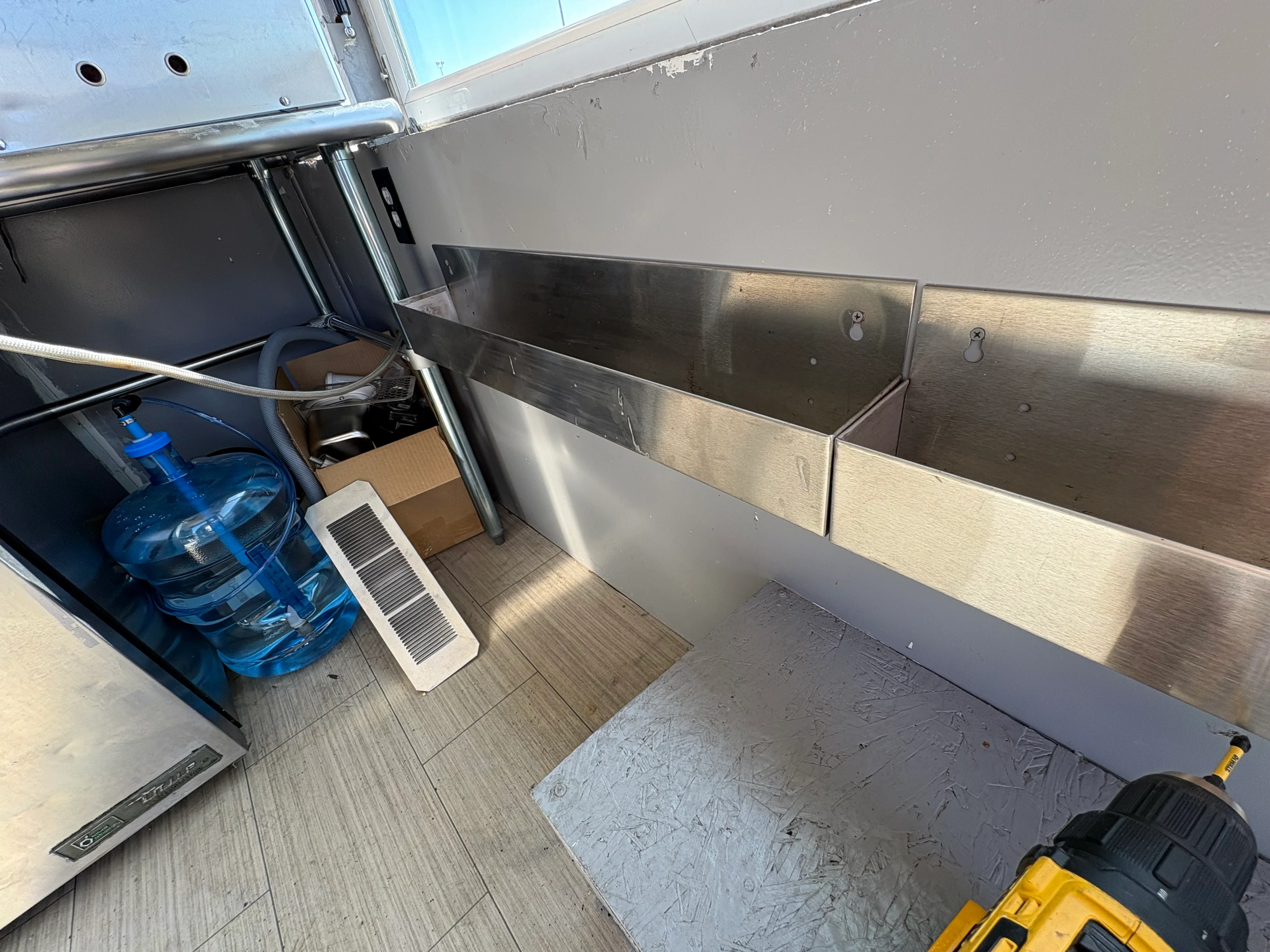 Interior of a food truck with stainless steel shelving