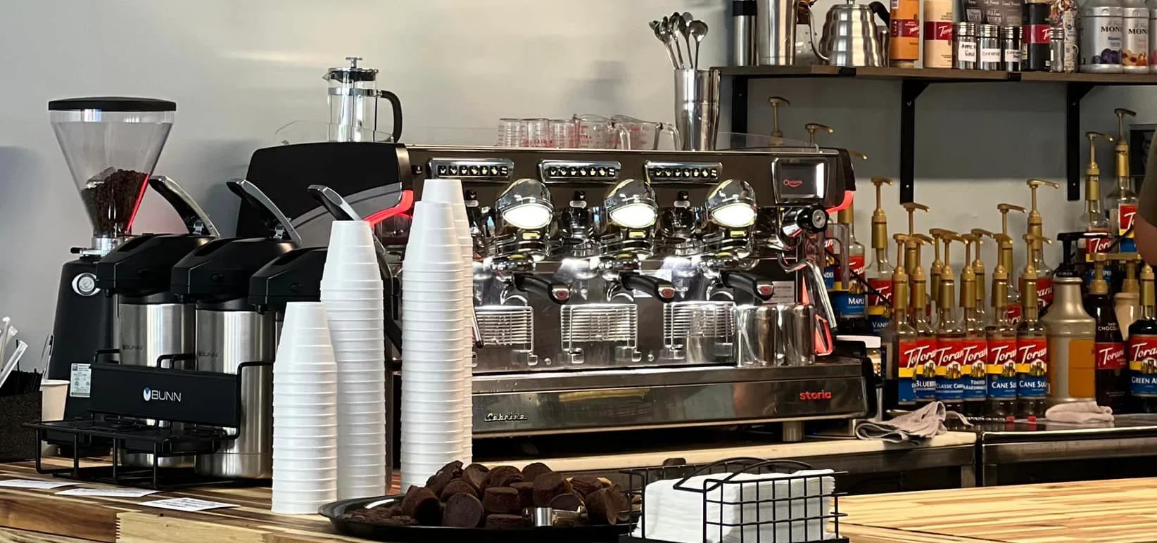 Coffee counter with espresso machine and pickup sign