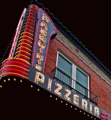 Classic pizzeria sign with neon lights
