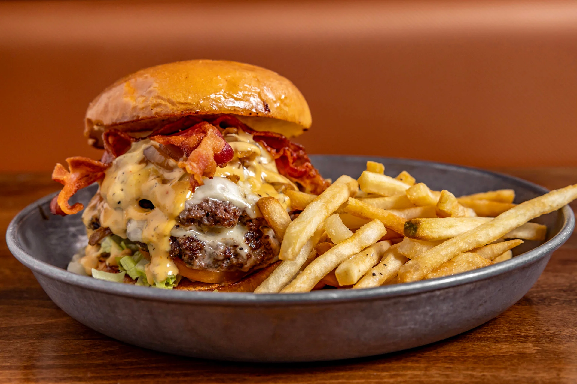 Juicy cheeseburger with bacon and fries