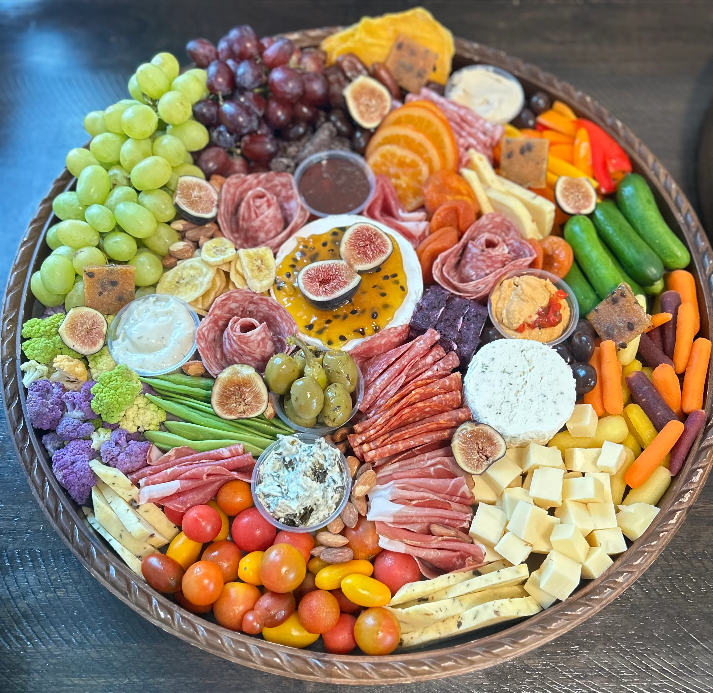 Artisan charcuterie board with assorted meats, cheeses, and fresh fruits
