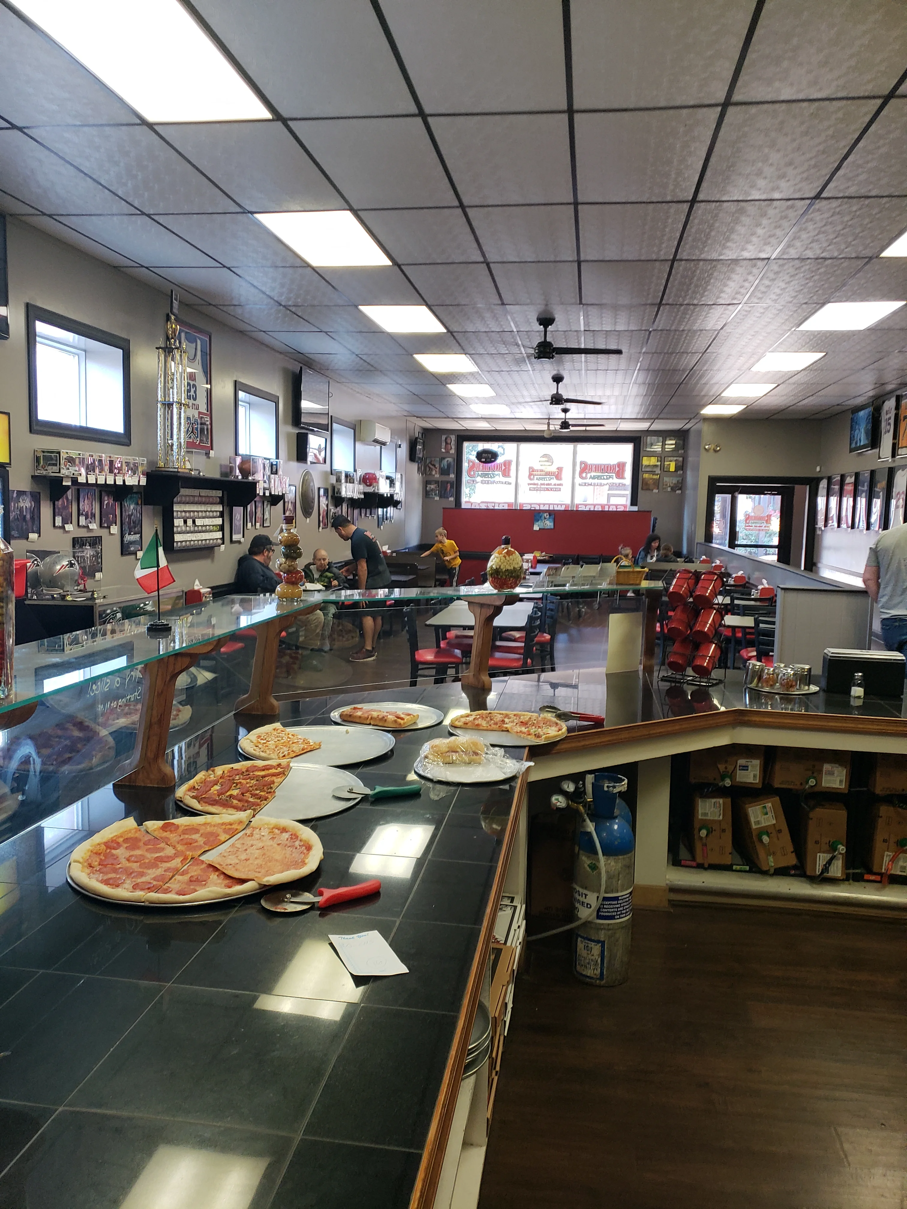Cozy pizzeria interior with fresh pizzas on display