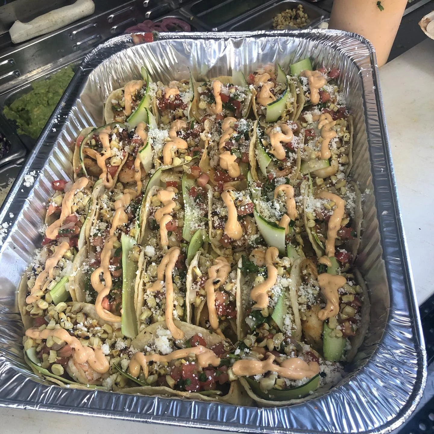 Colorful Mexican street tacos topped with sauce and cheese