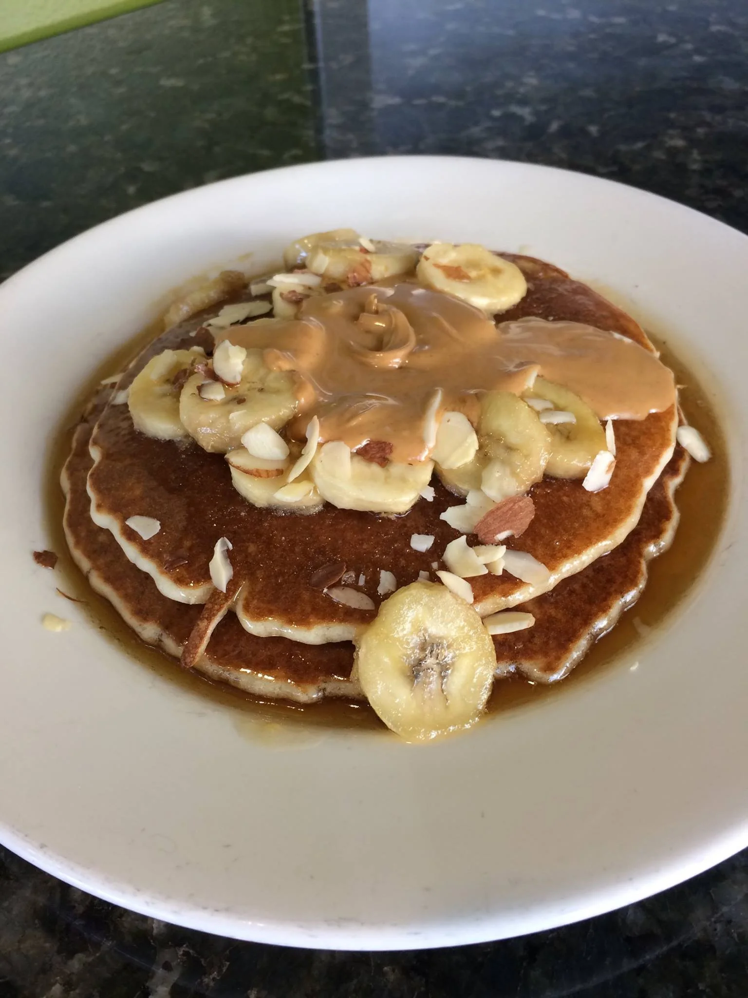Fluffy banana pancakes with peanut butter and syrup