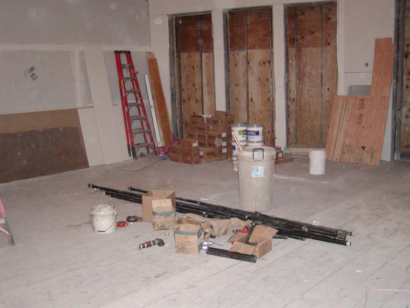 Empty restaurant space under construction with tools and materials scattered