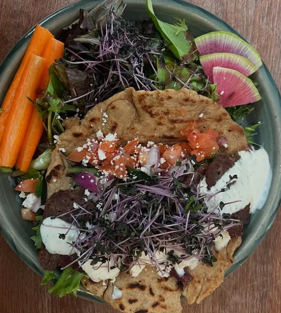 Freshly made Mexican quesadilla served with salad and colorful vegetables