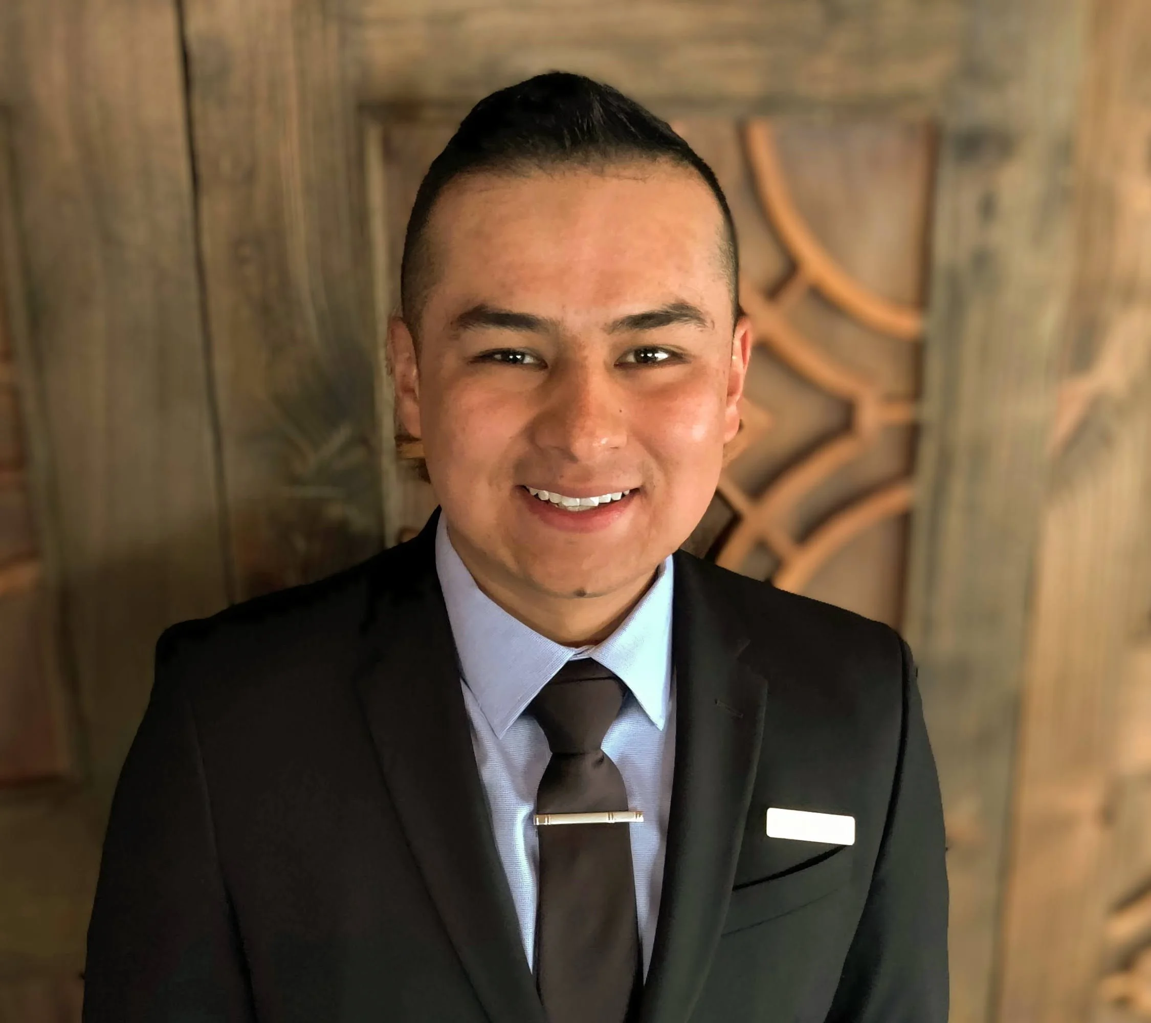 Professional man in a suit smiling in a restaurant setting