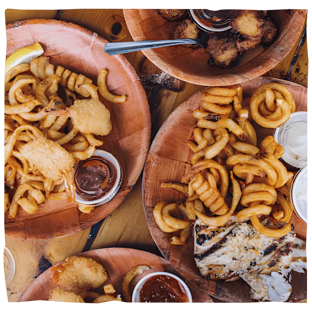 Seafood platters with grilled fish, calamari, fried shrimp, and seasoned fries at Tarks of Dania in Dania Beach, Florida
