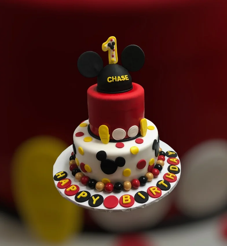 Colorful birthday cake with Mickey Mouse theme for a child's celebration