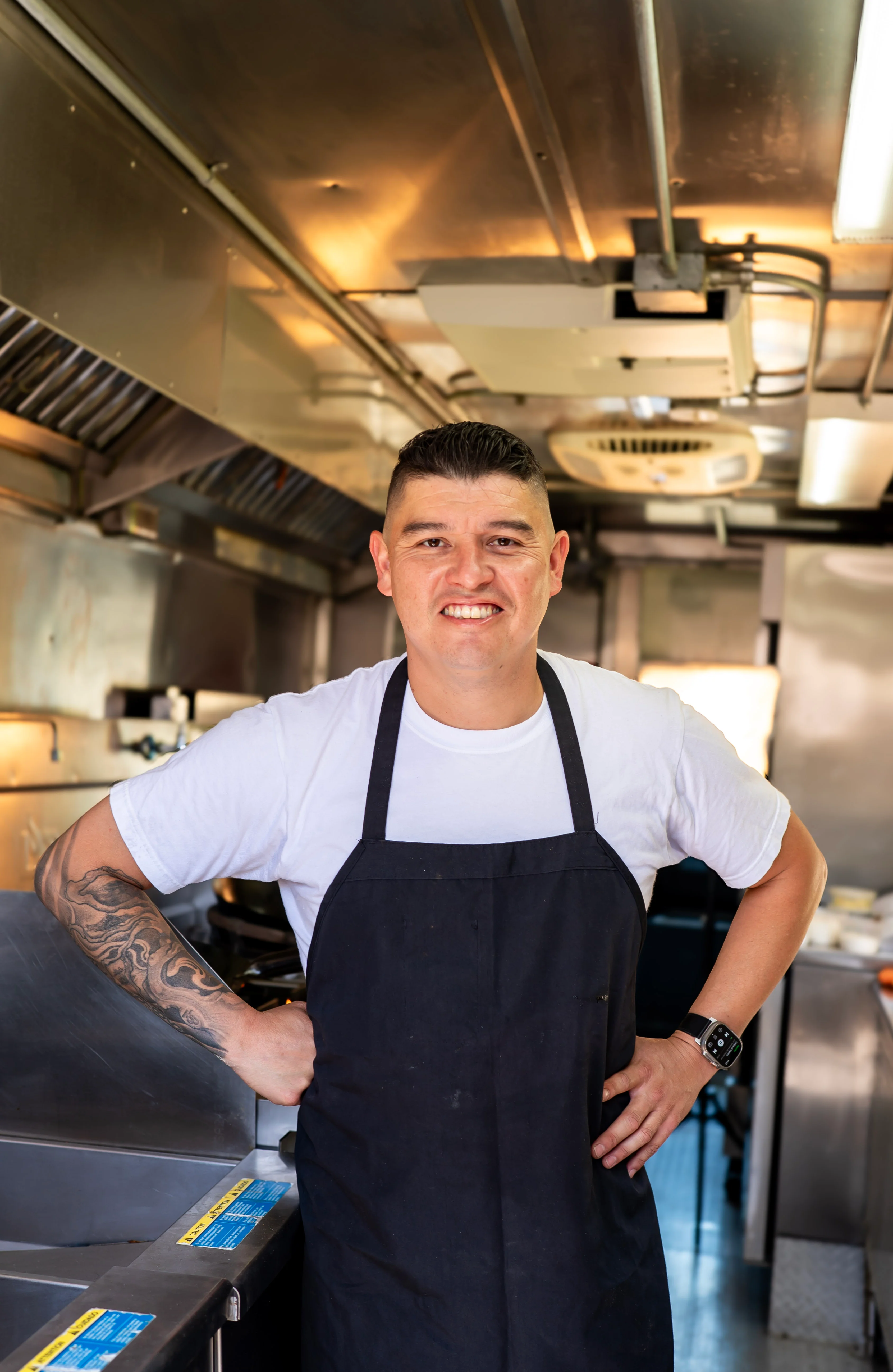 Chef smiling in a food truck kitchen