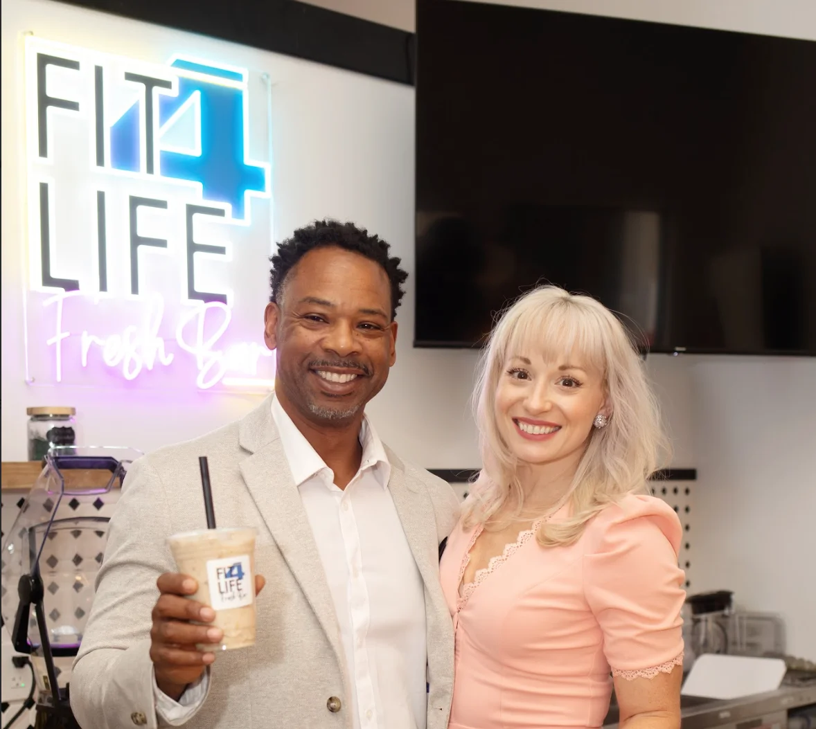 Owners of Fit4Life Fresh Bar smiling at their vibrant juice bar