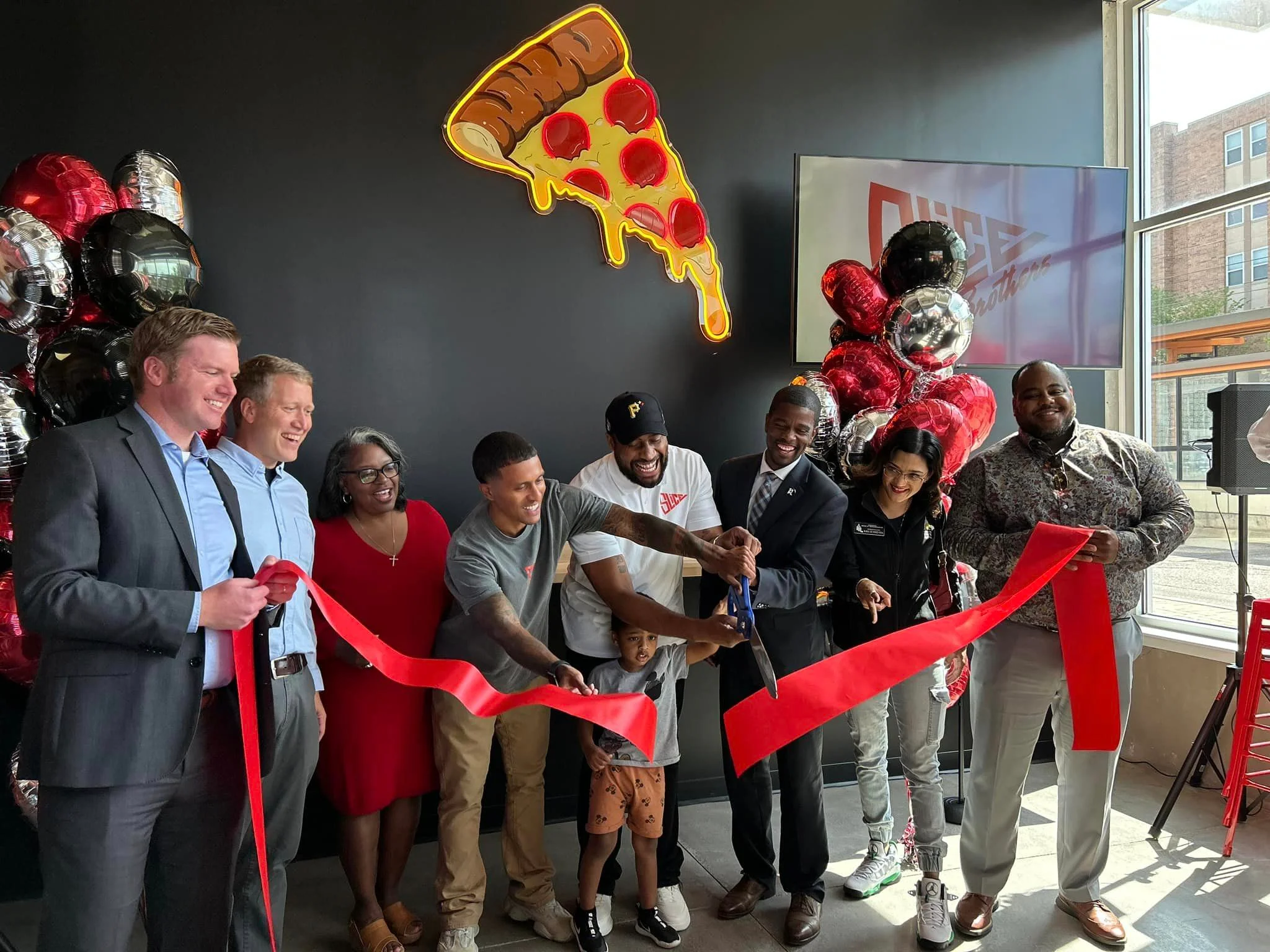 Ribbon-cutting ceremony for a new pizza restaurant opening