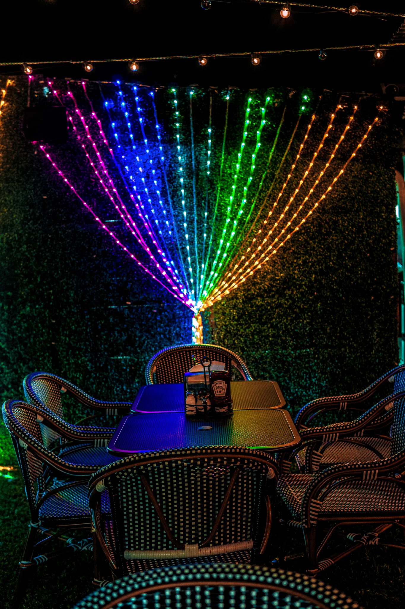 Vibrant restaurant patio with colorful LED lights