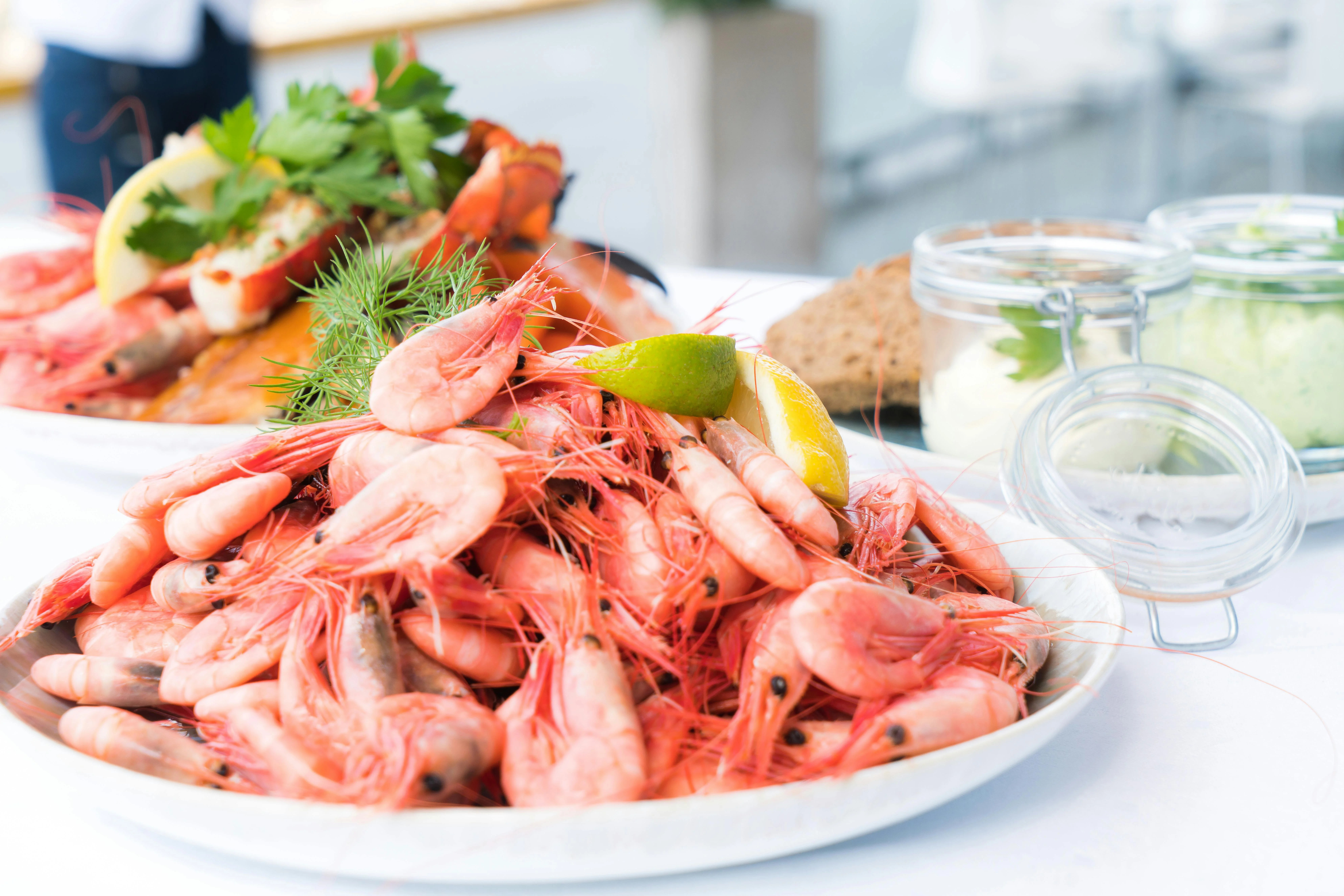 Plate of fresh shrimp served with lemon and herbs