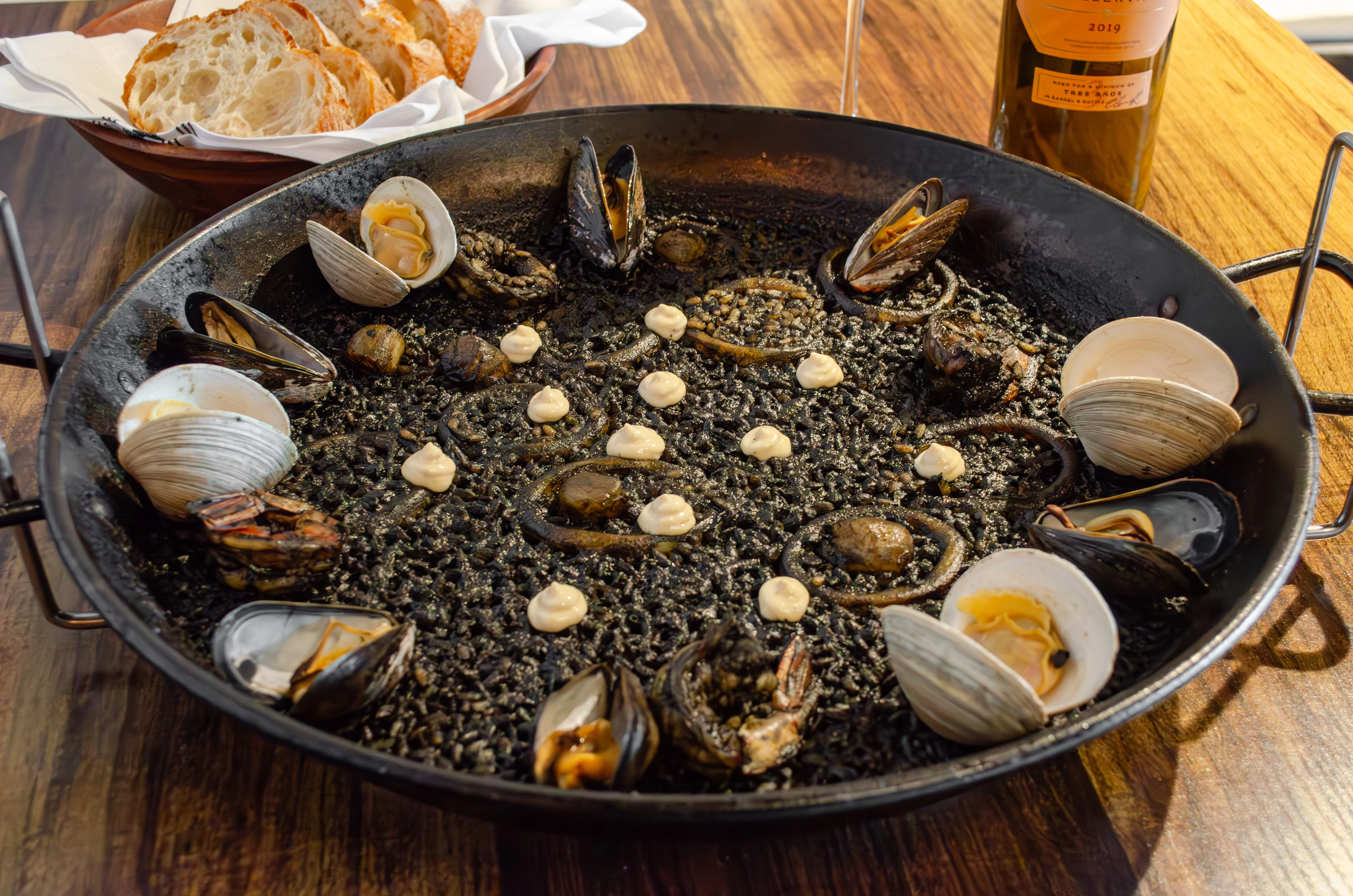 Spanish seafood paella with black rice and shellfish