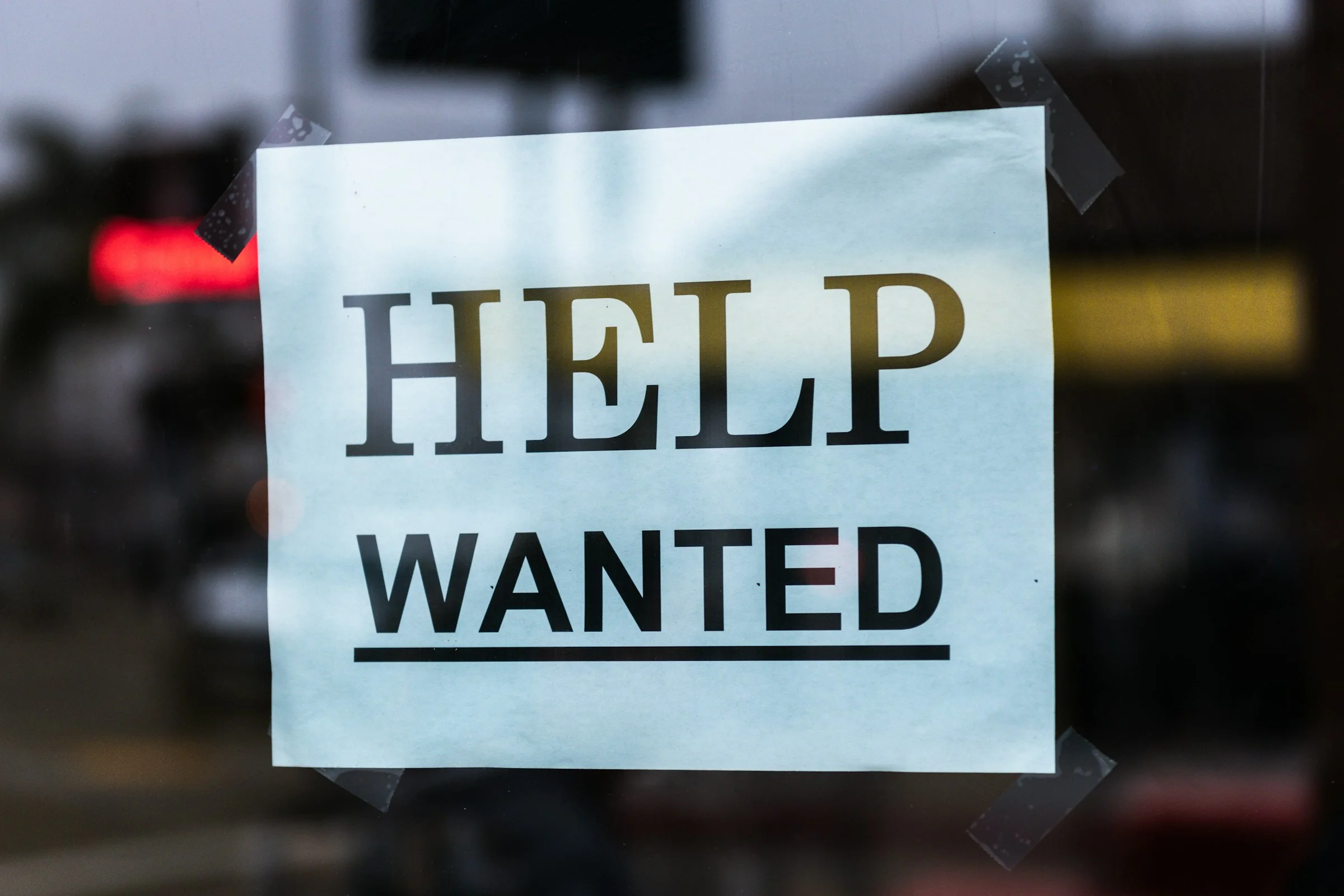 Help wanted sign in a restaurant window
