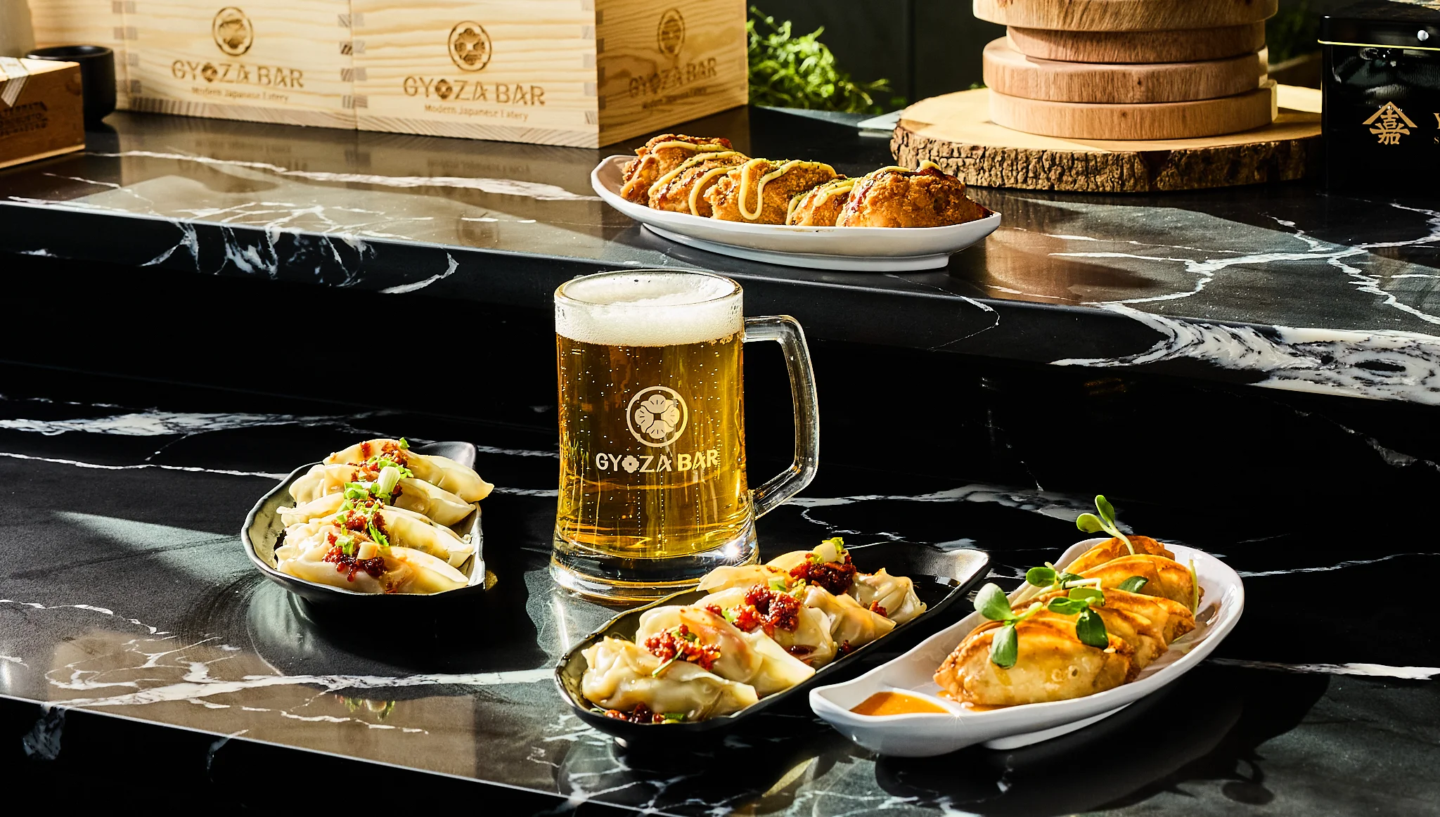 Japanese gyoza dumplings with beer in a modern restaurant setting