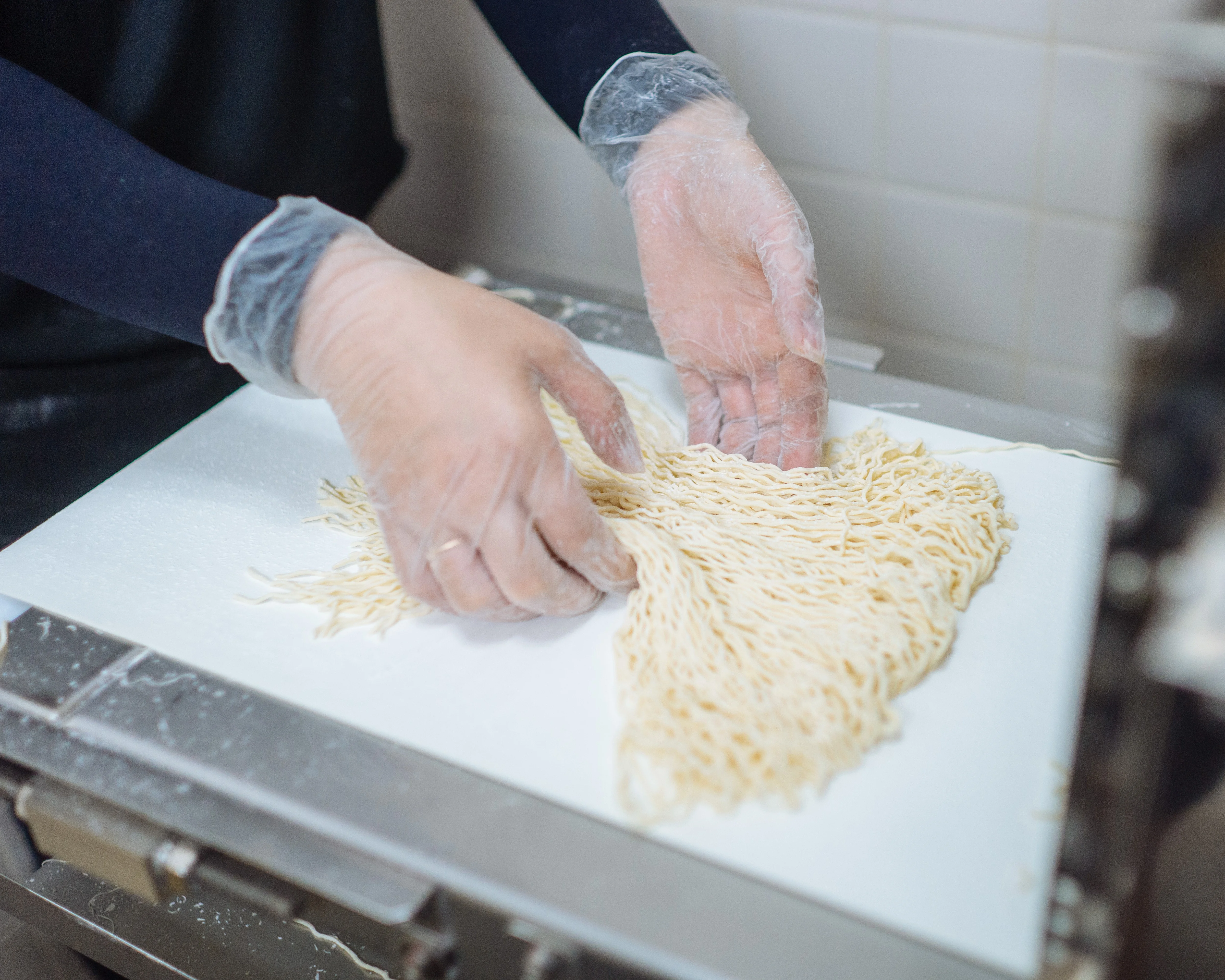 Freshly prepared ramen noodles being portioned at Goma Tei.