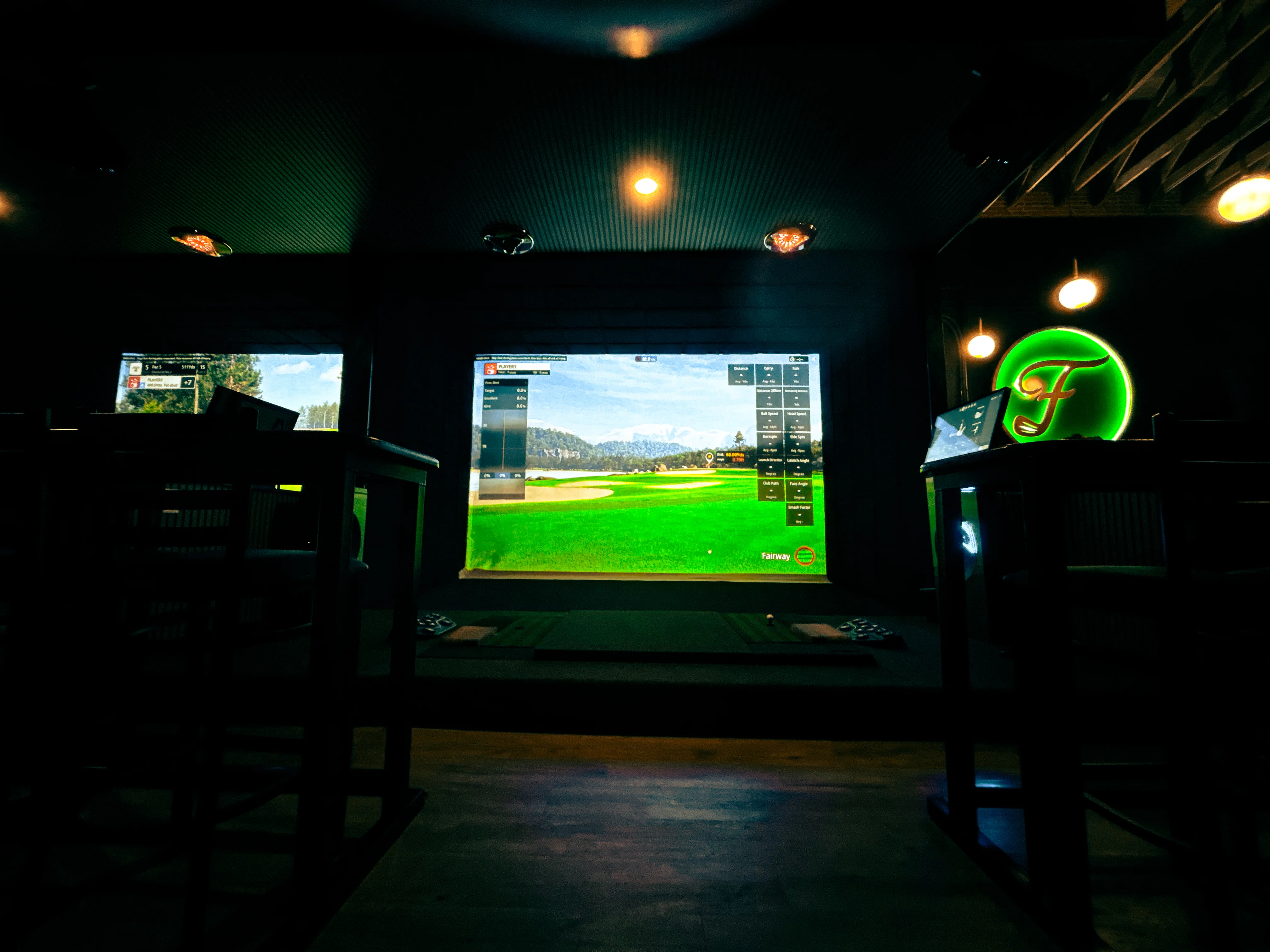 Indoor golf simulator setup in a modern lounge space.