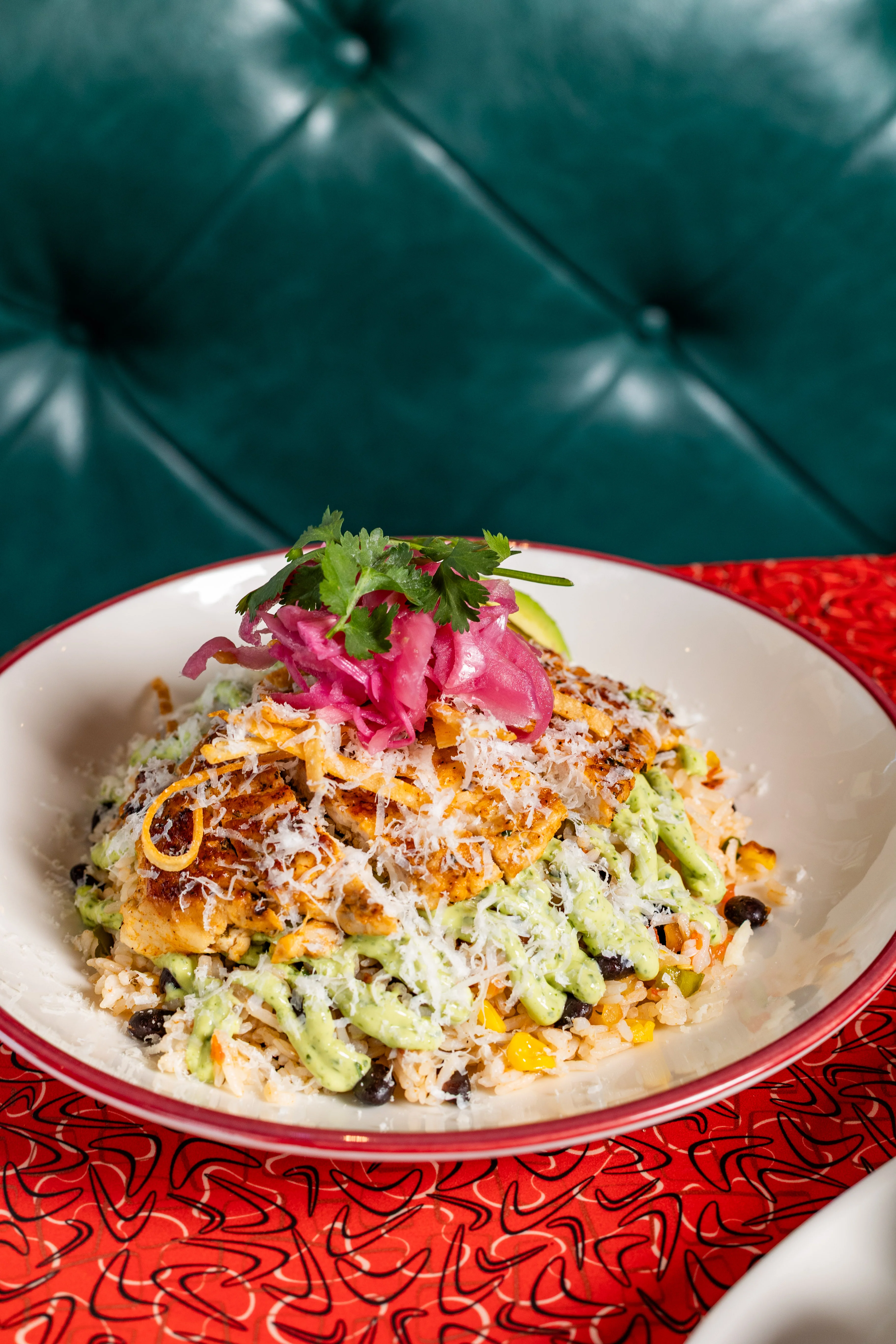 Vibrant Mexican rice bowl with grilled chicken and avocado sauce