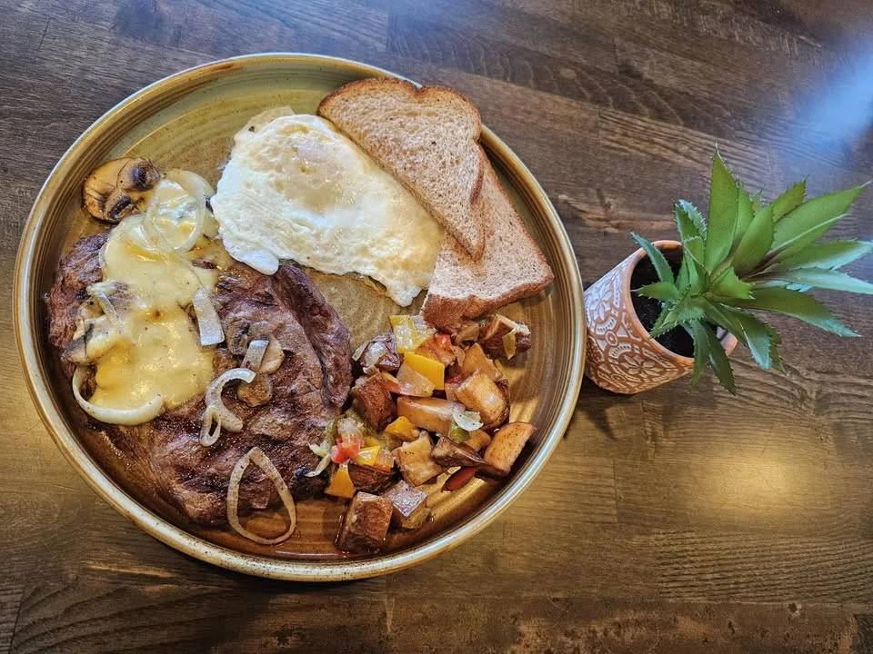 Hearty American breakfast plate with steak and eggs
