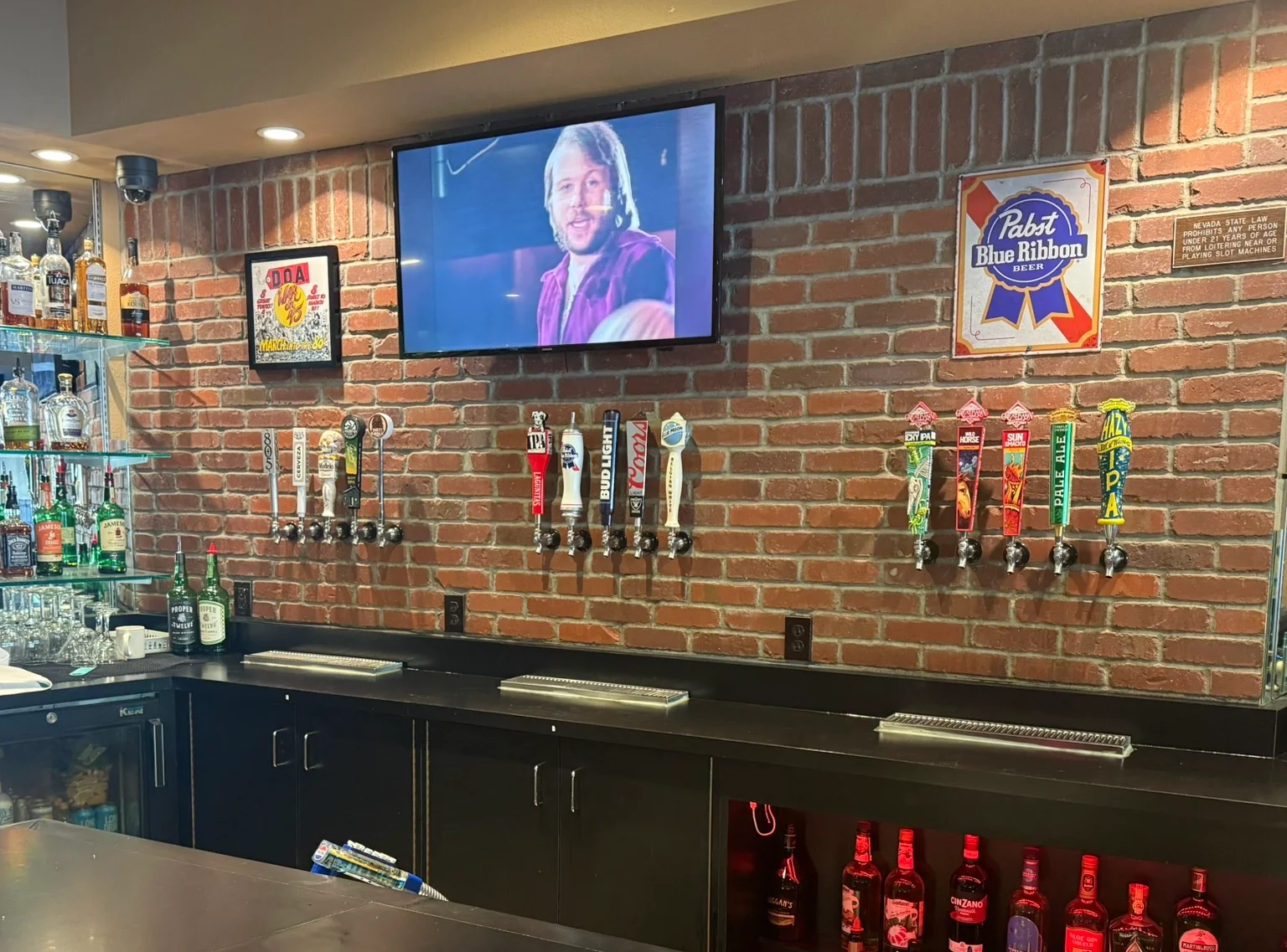 Modern bar counter with craft beer taps and liquor display