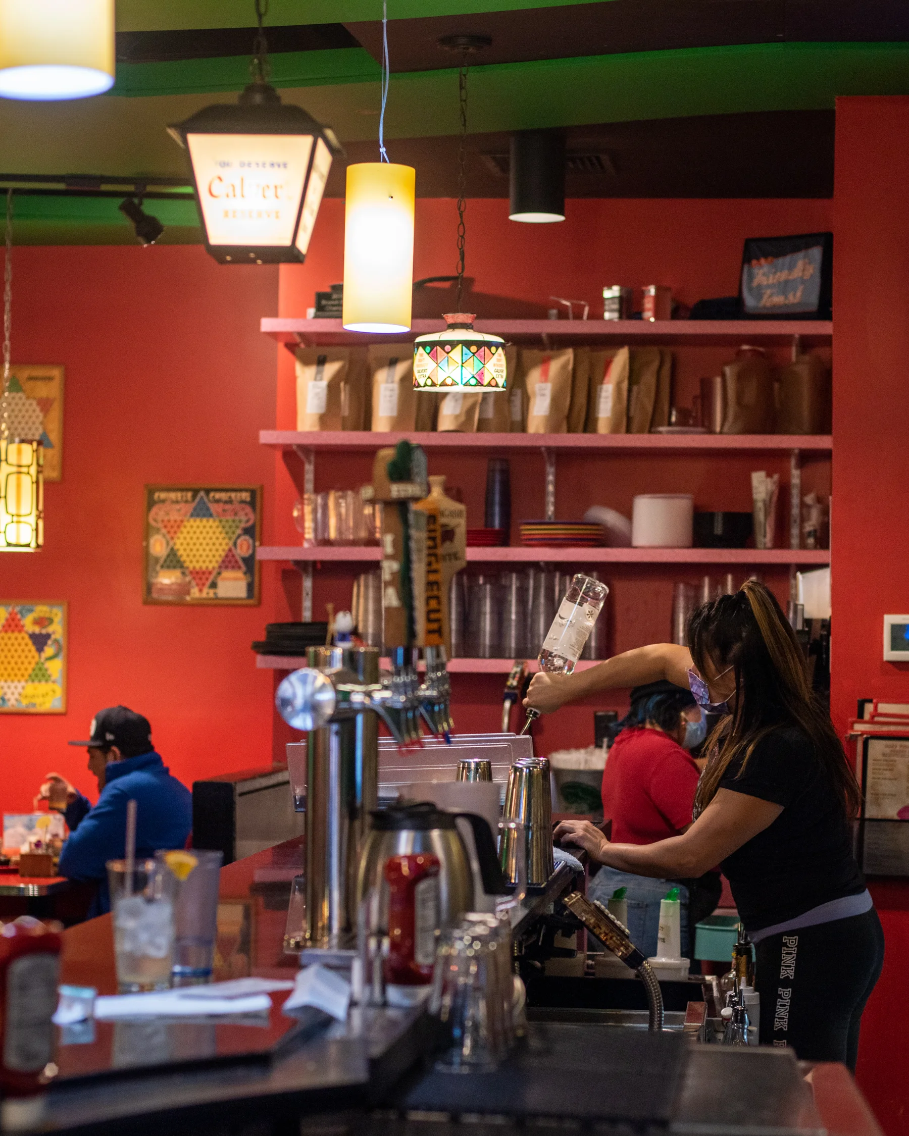 Bartender preparing drinks at a vibrant restaurant bar