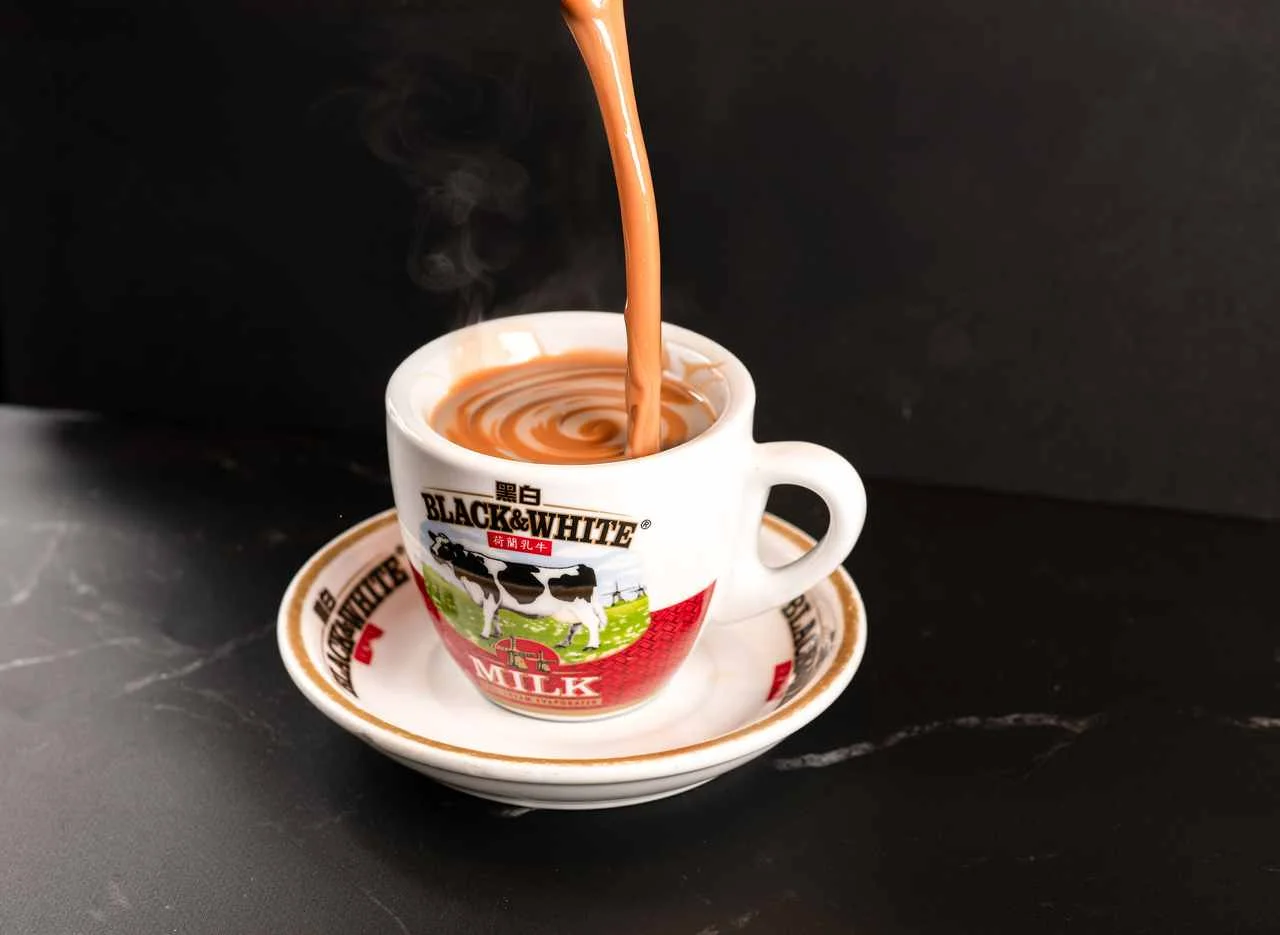 Pouring Malaysian teh tarik into a cup