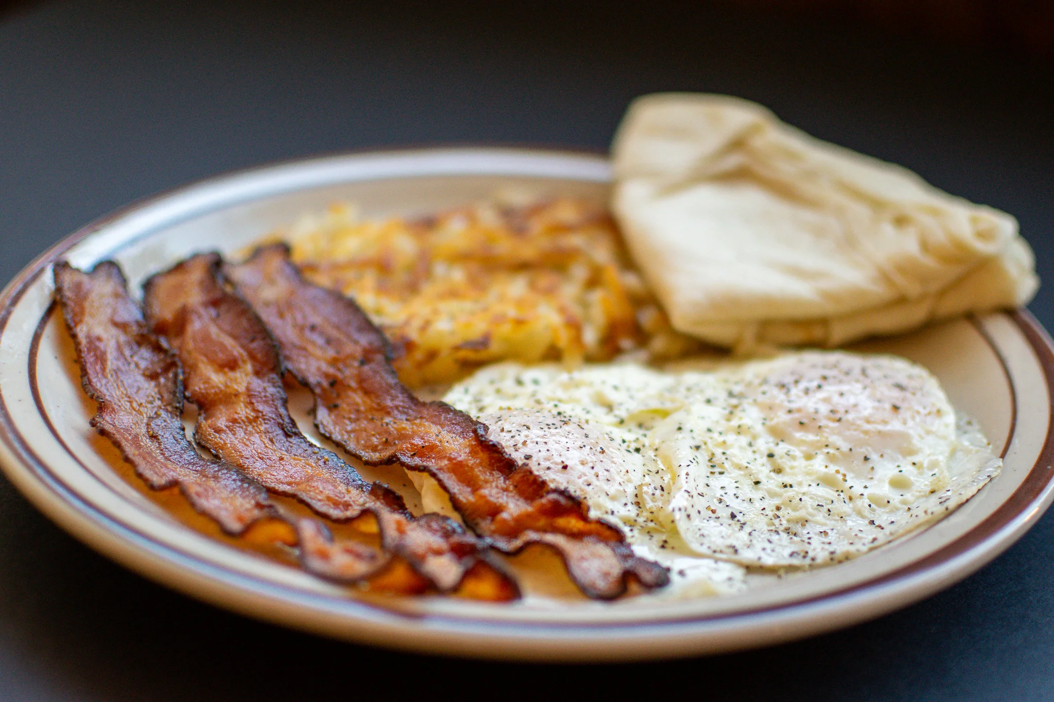 Classic American breakfast with eggs, bacon, and hash browns