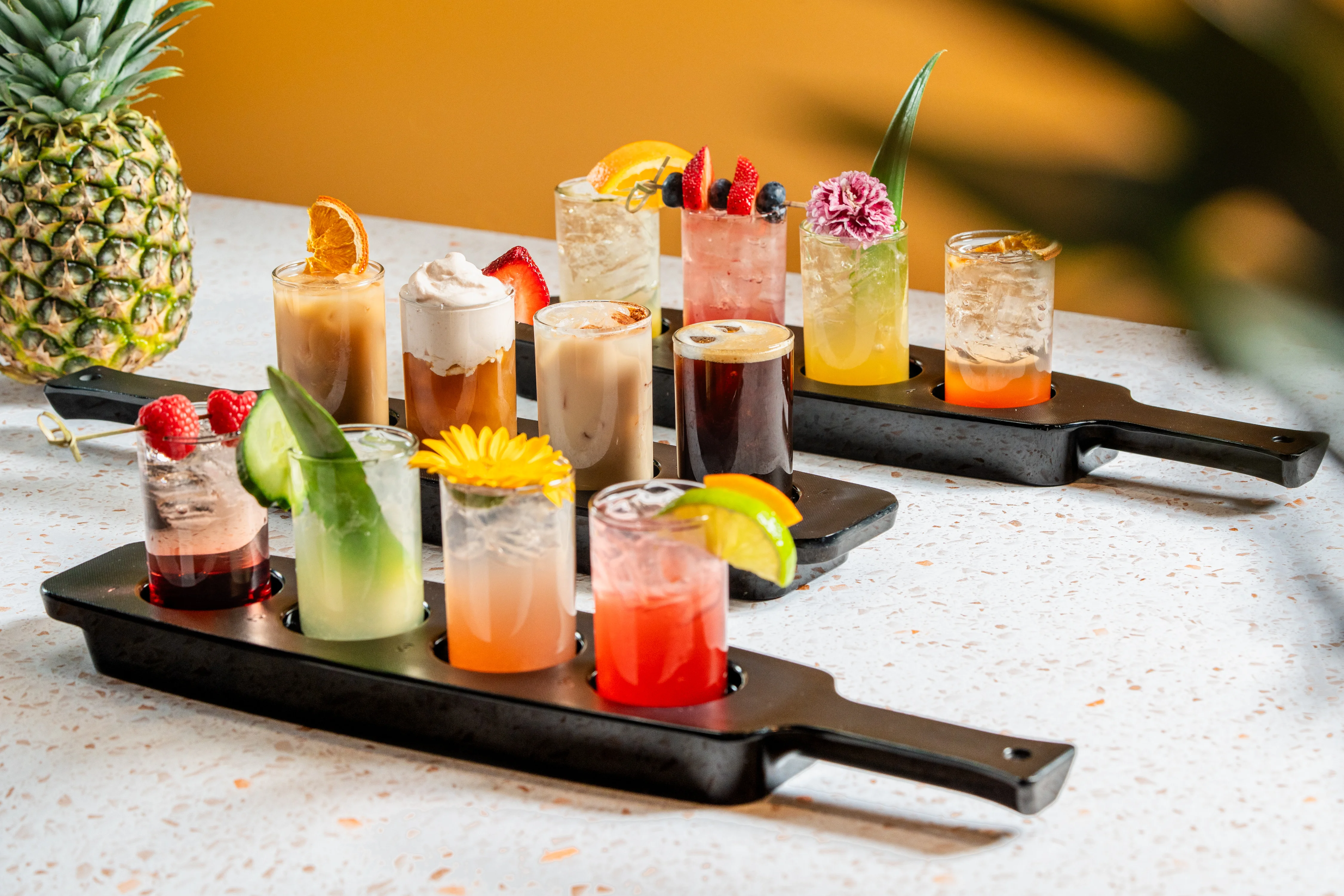 Colorful tropical cocktails and mocktails garnished with fresh fruit
