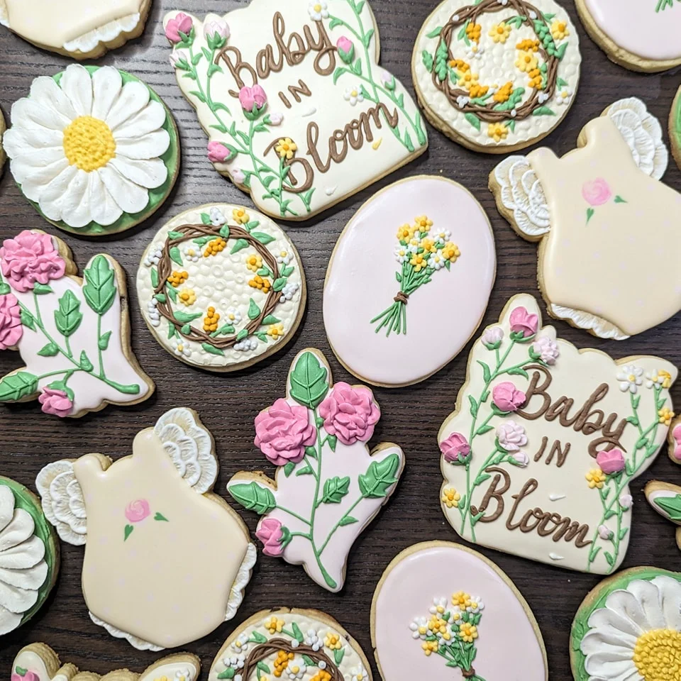 Decorative cookies for a baby shower with floral designs