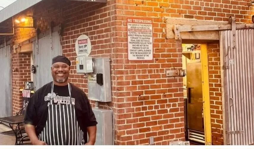 Welcoming restaurant exterior with chef and open sign