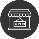 Open restaurant storefront with welcoming sign
