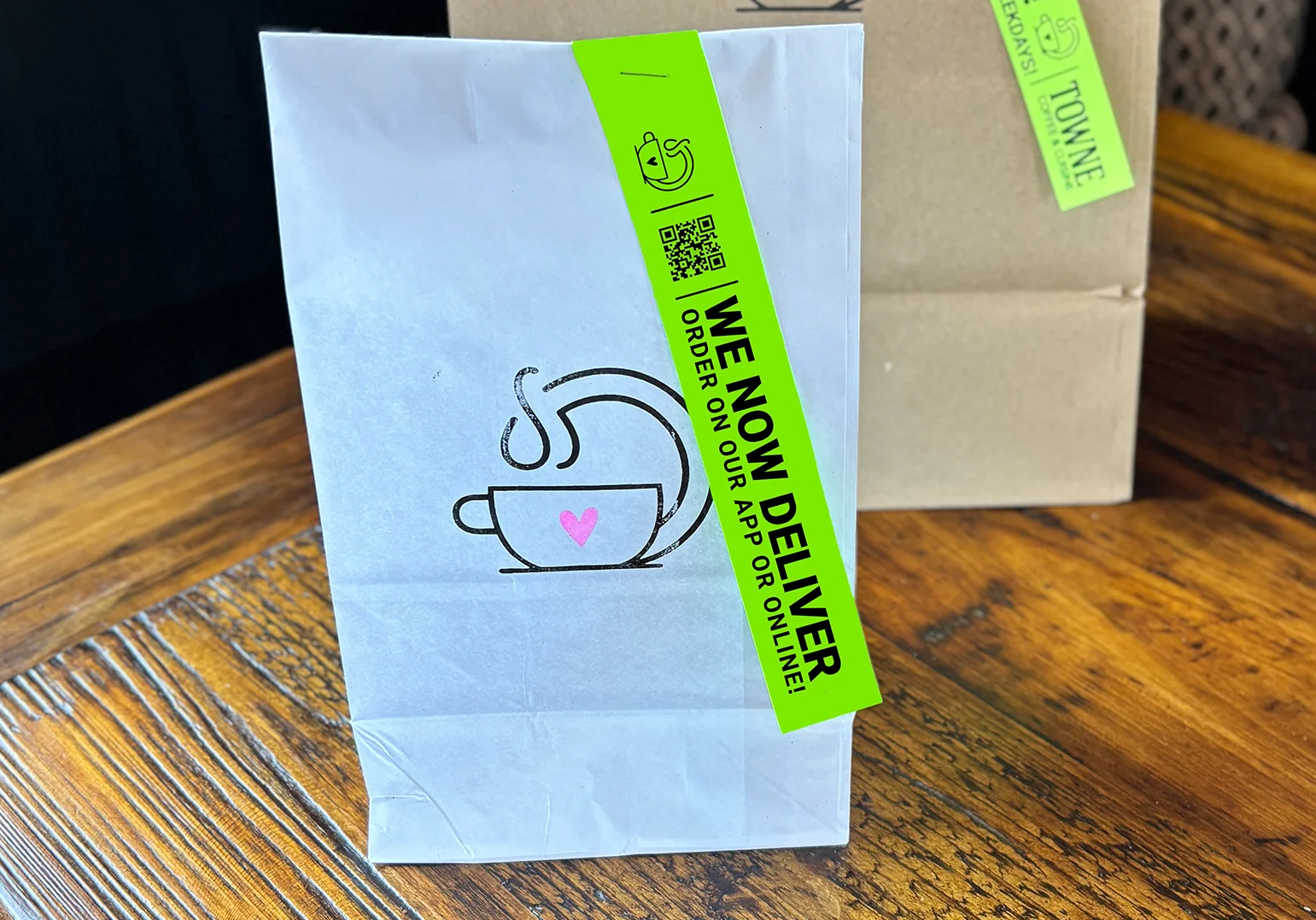 Takeout bags with delivery signs in a cozy restaurant setting
