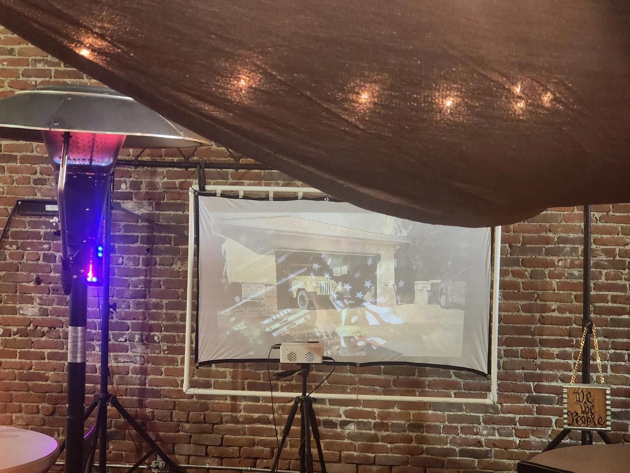 Cozy restaurant interior with projector and warm lighting