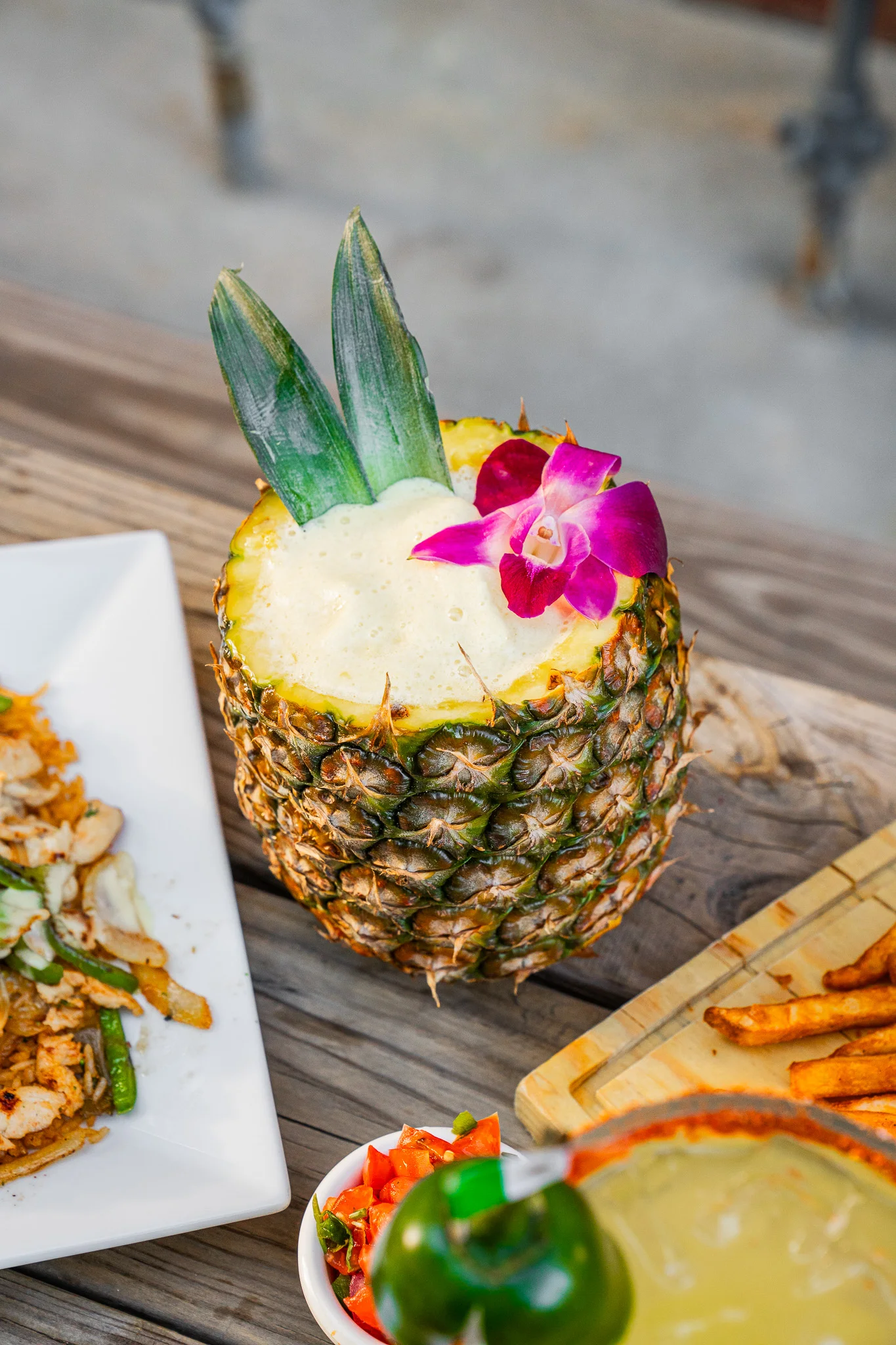 Pineapple cocktail garnished with an orchid flower