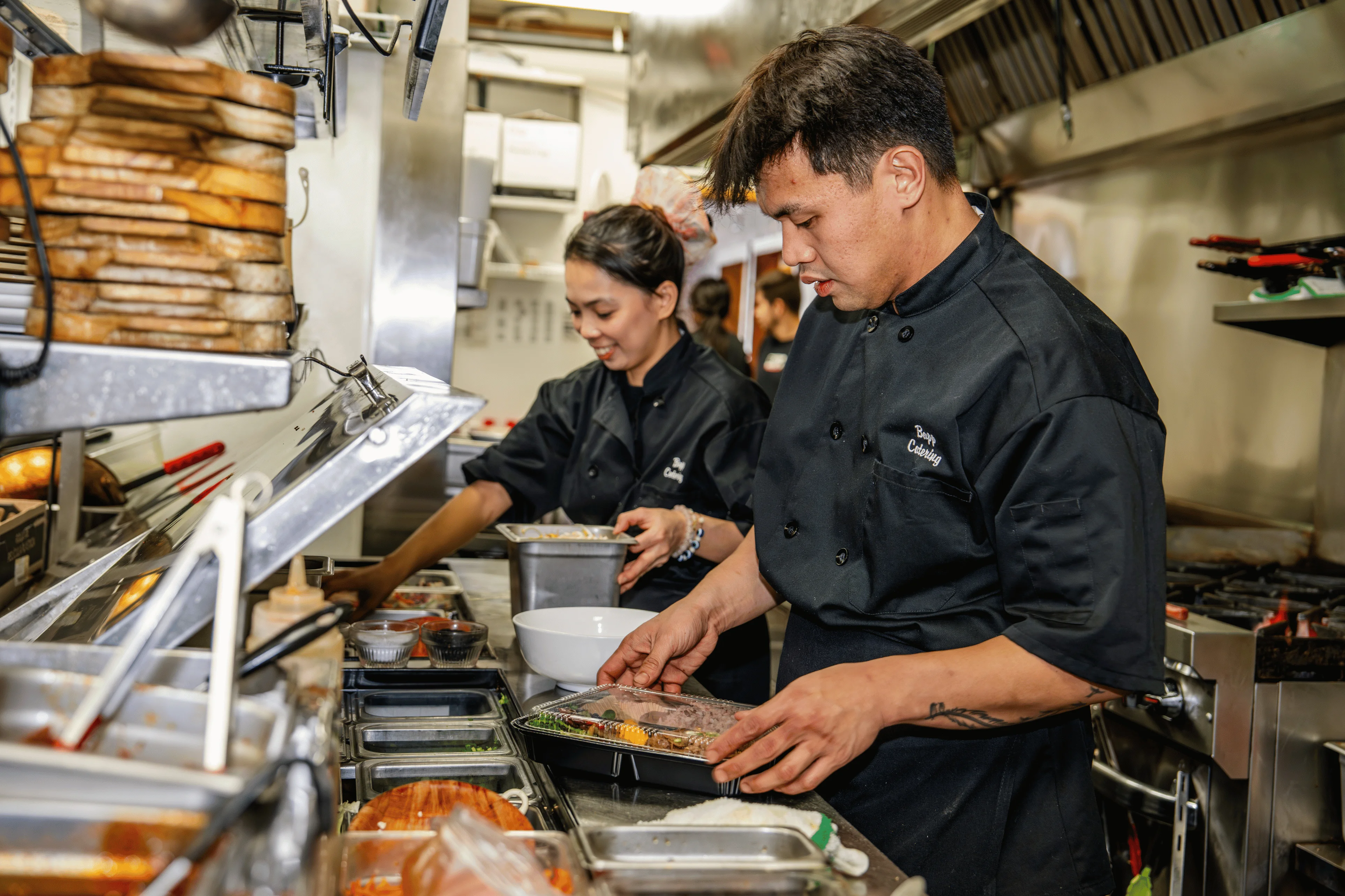 Chefs preparing dishes in a busy restaurant kitchen