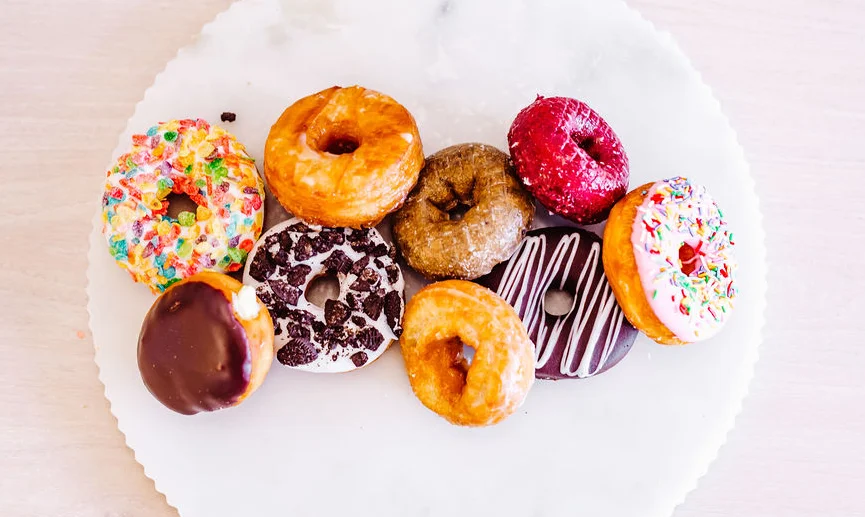 Colorful assortment of donuts on a marble platter