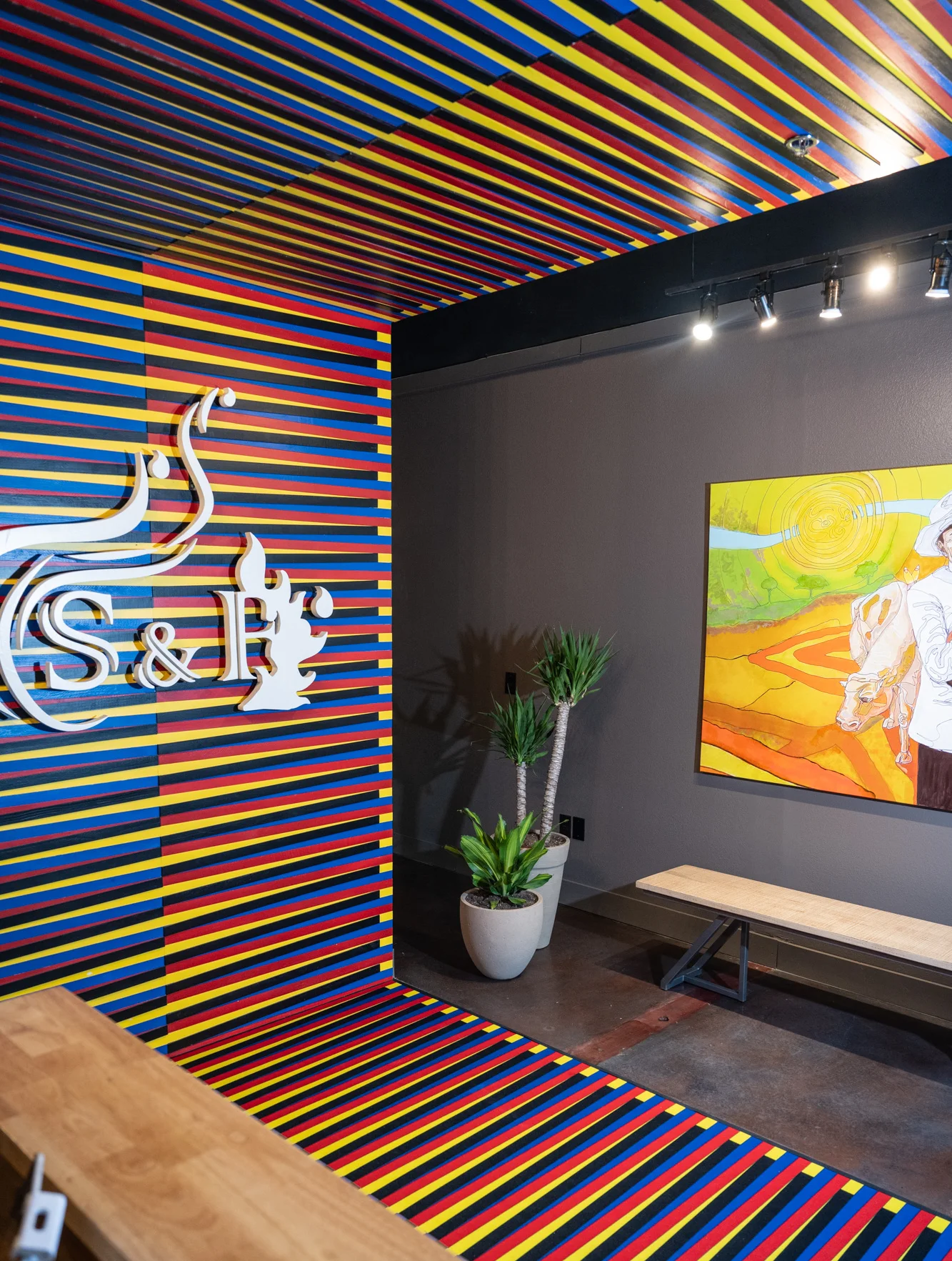 Vibrant restaurant interior with colorful striped walls and artwork