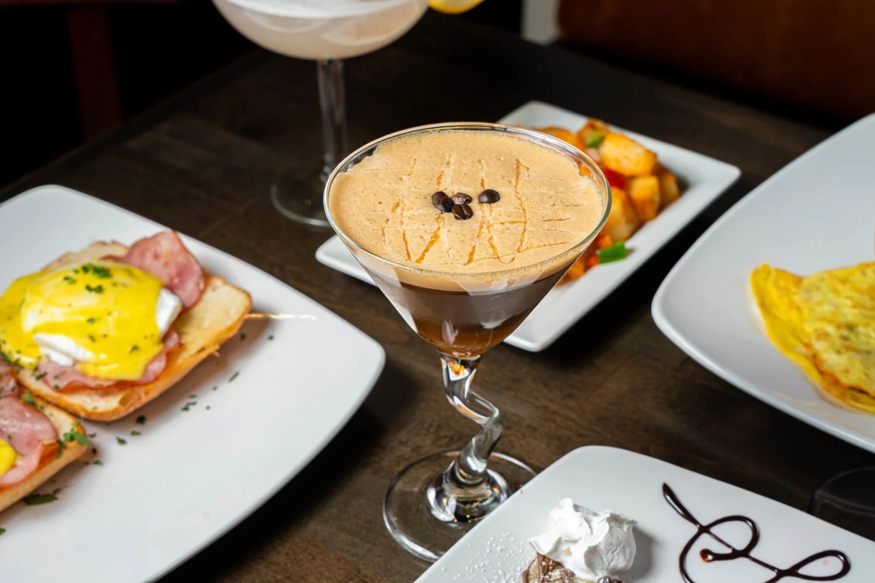 Coffee cocktail with creamy foam and coffee beans, served in a stylish glass