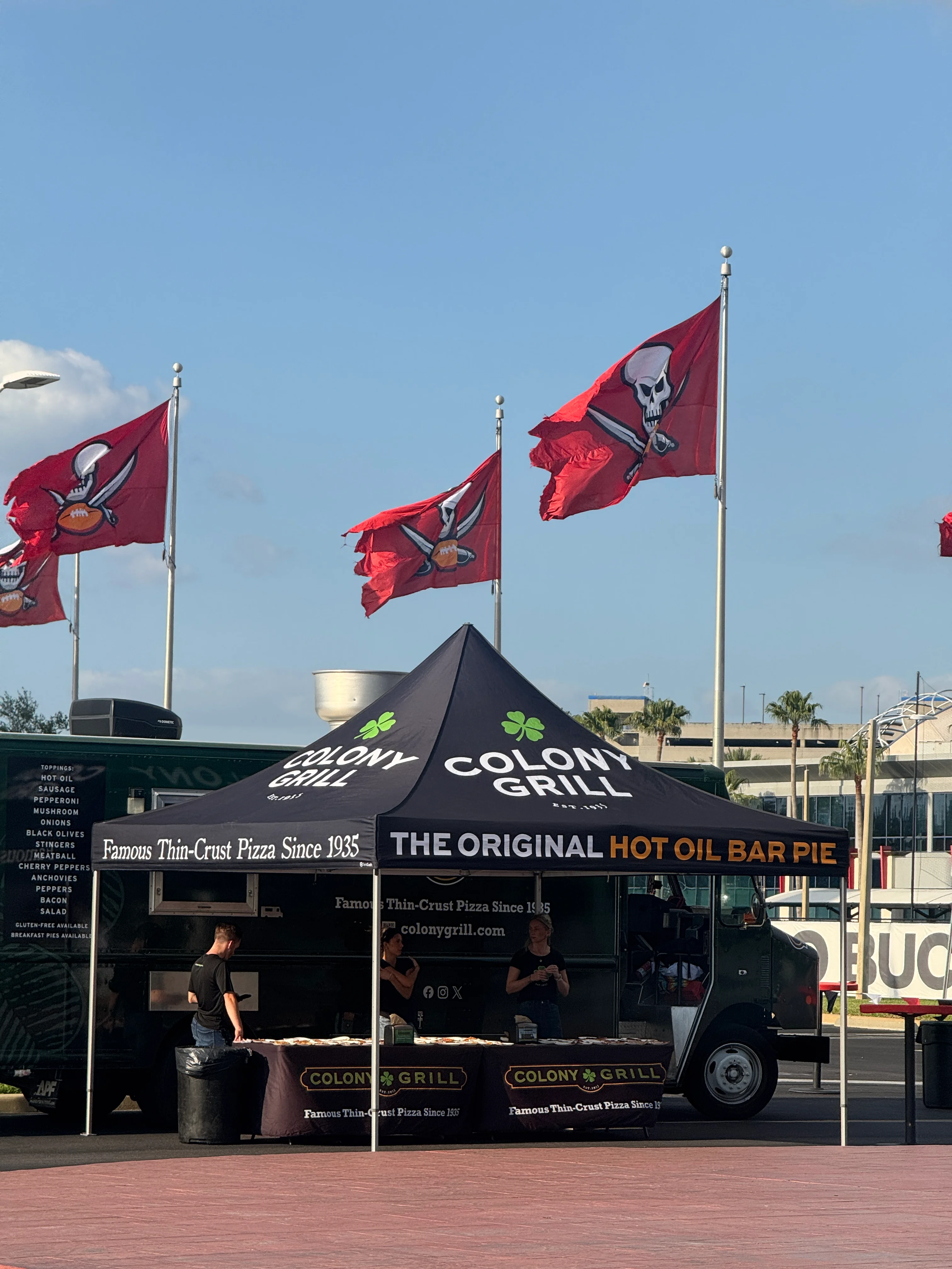 Colony Grill food truck serving famous thin-crust pizza at an outdoor event
