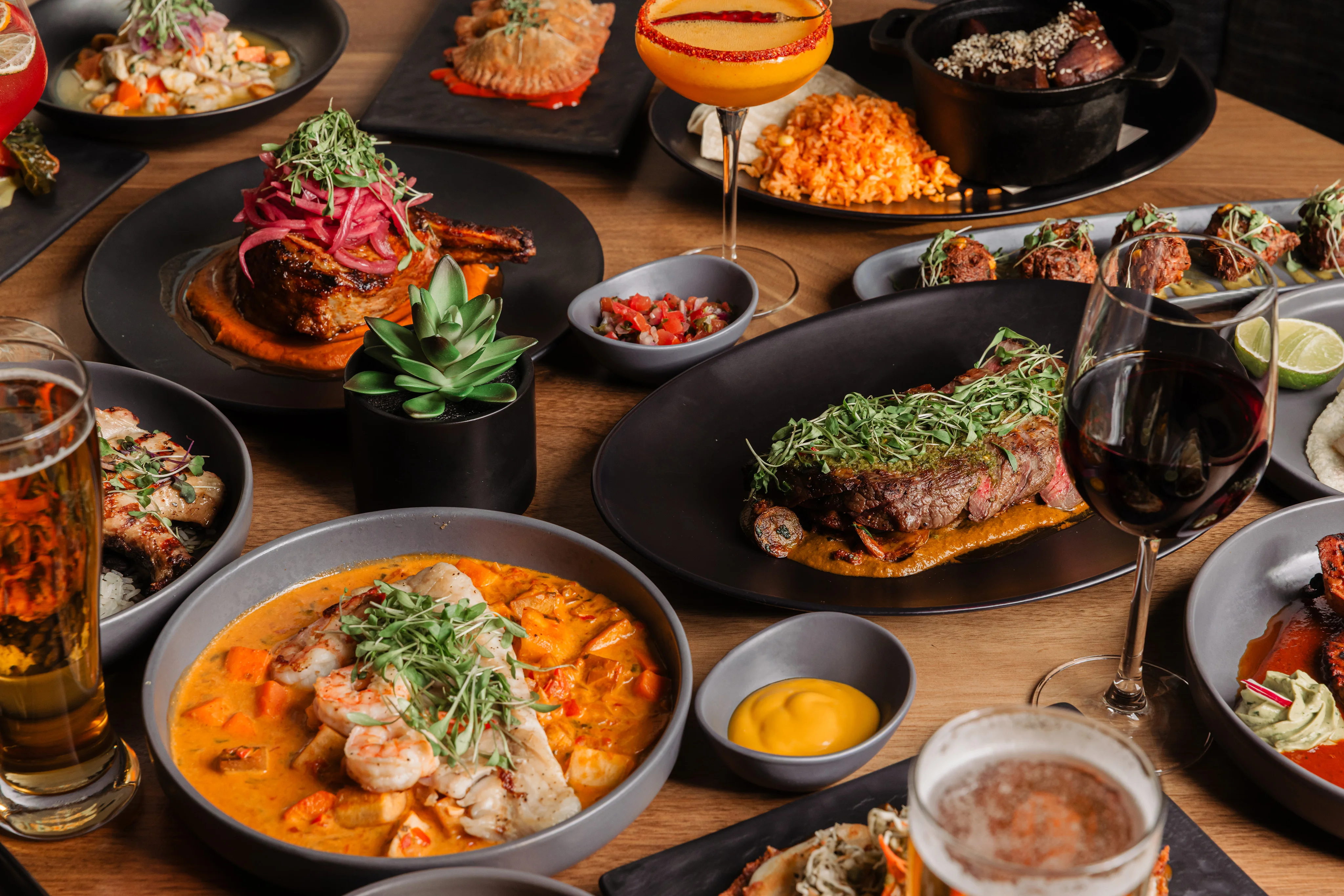 Colorful Mexican feast with grilled meats and seafood dishes