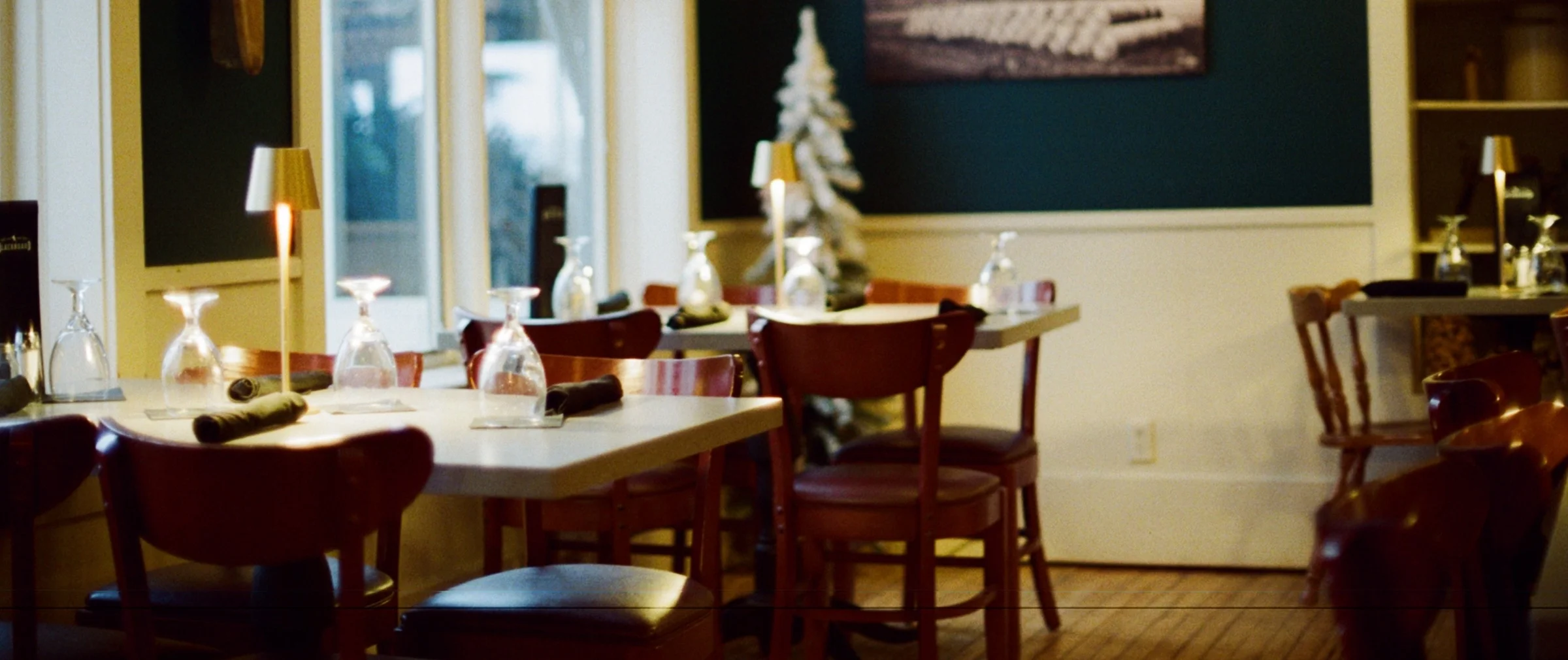 Cozy restaurant interior with warm lighting and elegant table settings