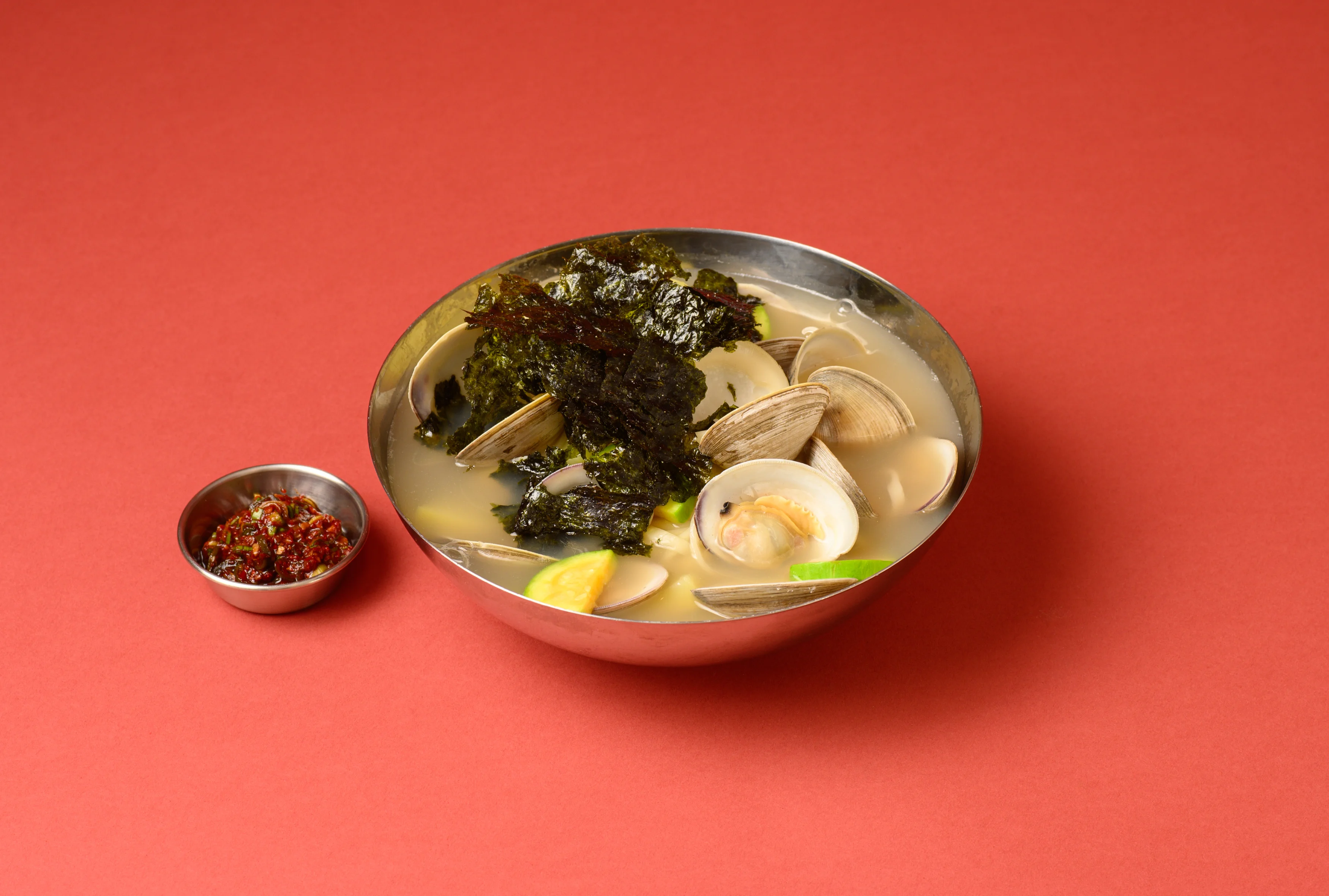 Korean clam soup with seaweed and spicy sauce
