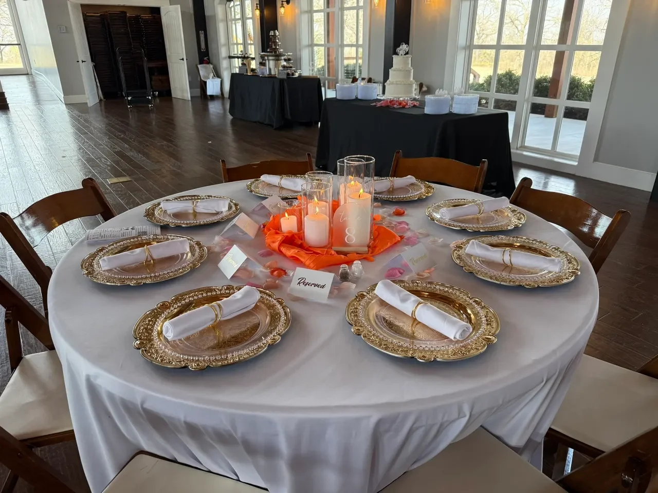 Elegant dining setup with gold plates and candles
