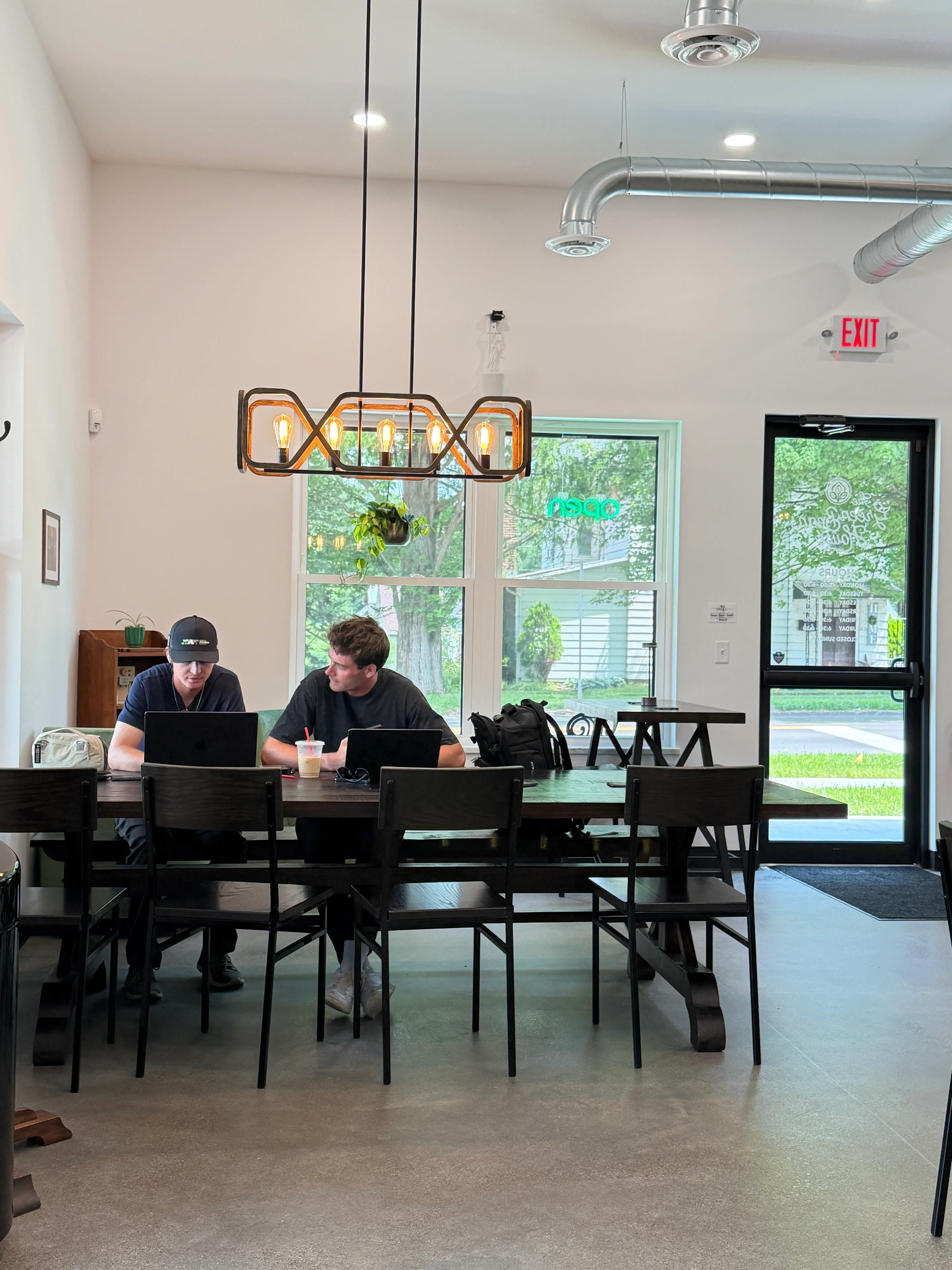 Modern restaurant interior with two people working at a communal table