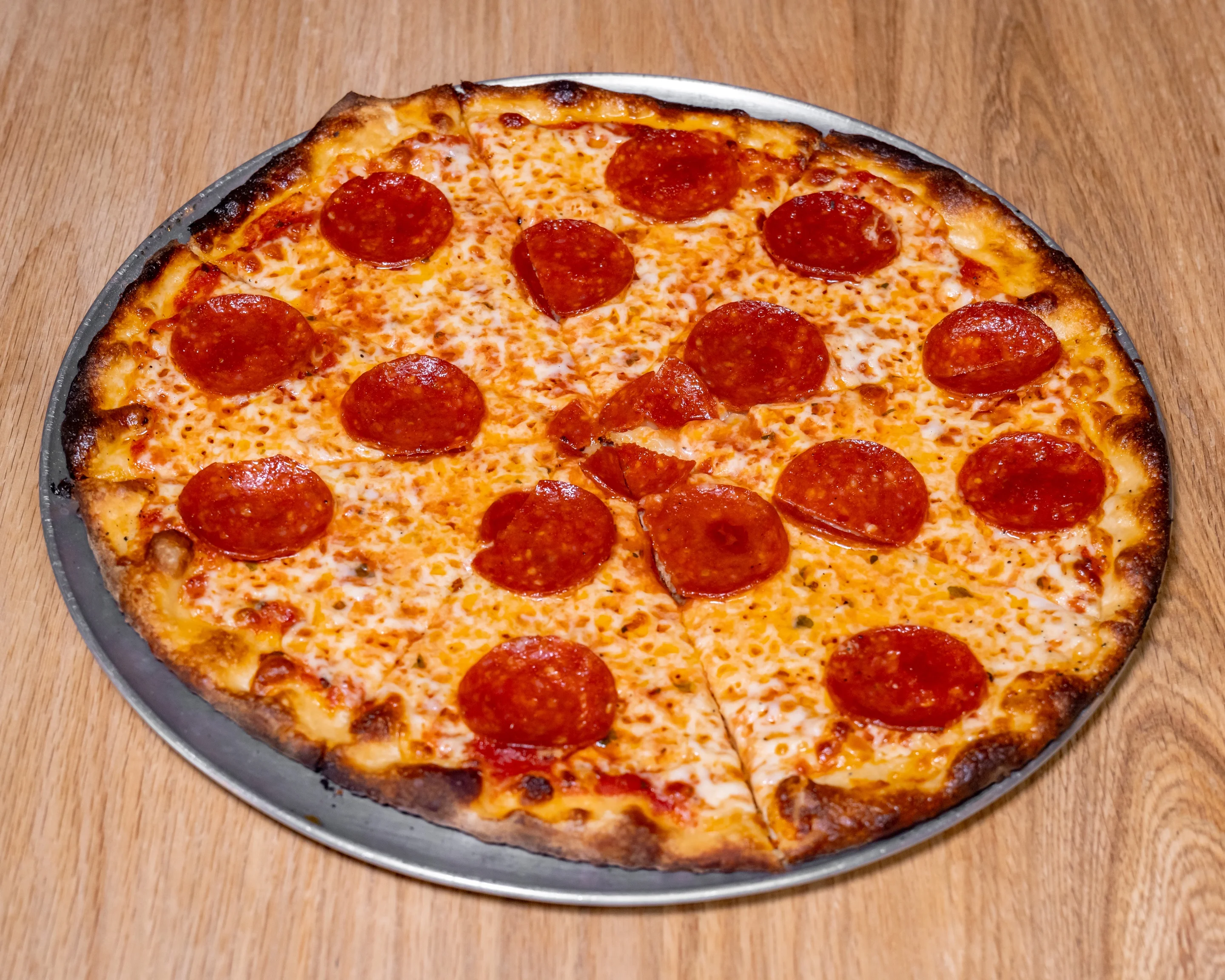 Classic pepperoni pizza on a wooden table