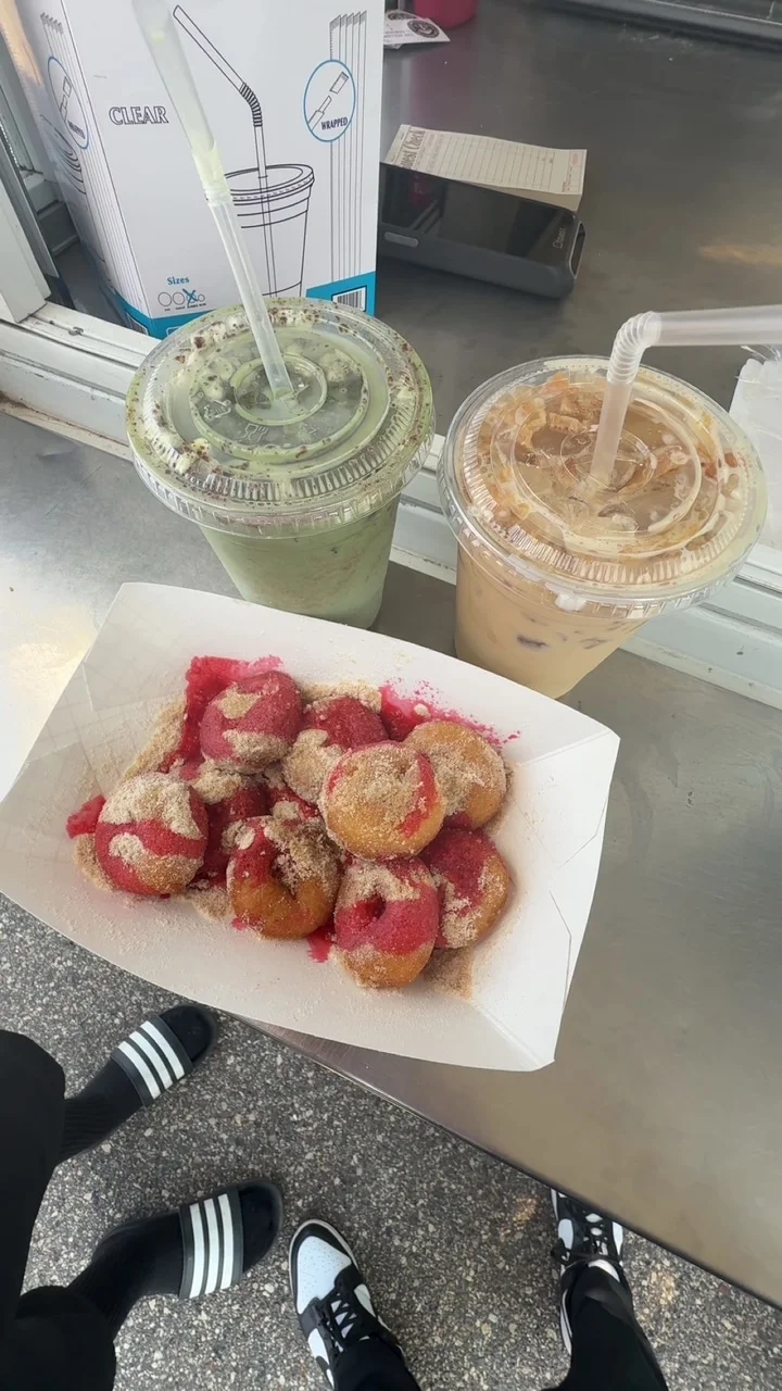 Colorful churros dusted with cinnamon sugar and served with iced beverages