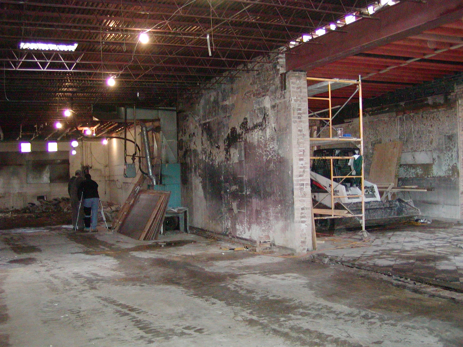 Renovation of a restaurant space with exposed walls and construction equipment